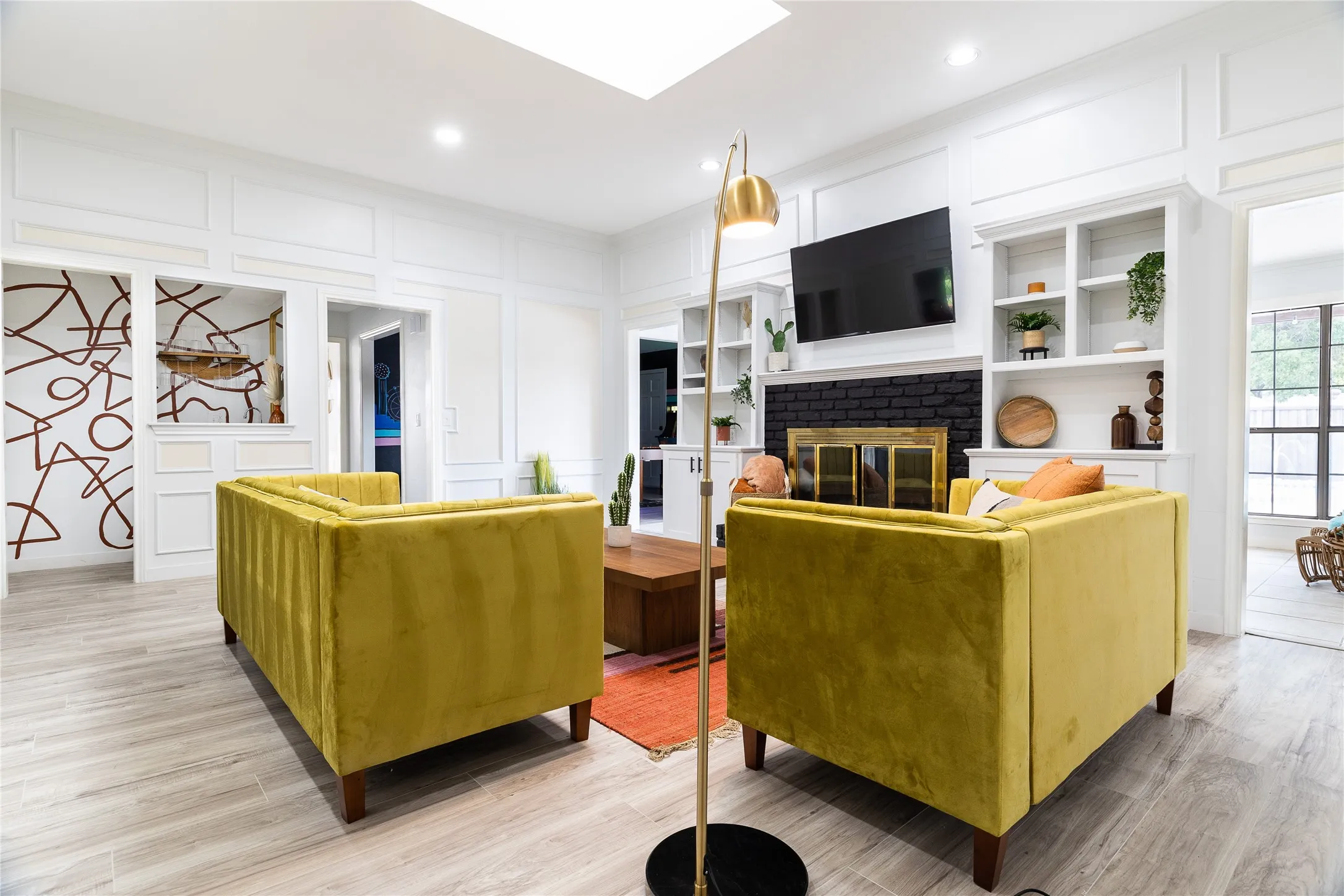Recessed lighting and skylight illuminate the interior, featuring wood-finish flooring