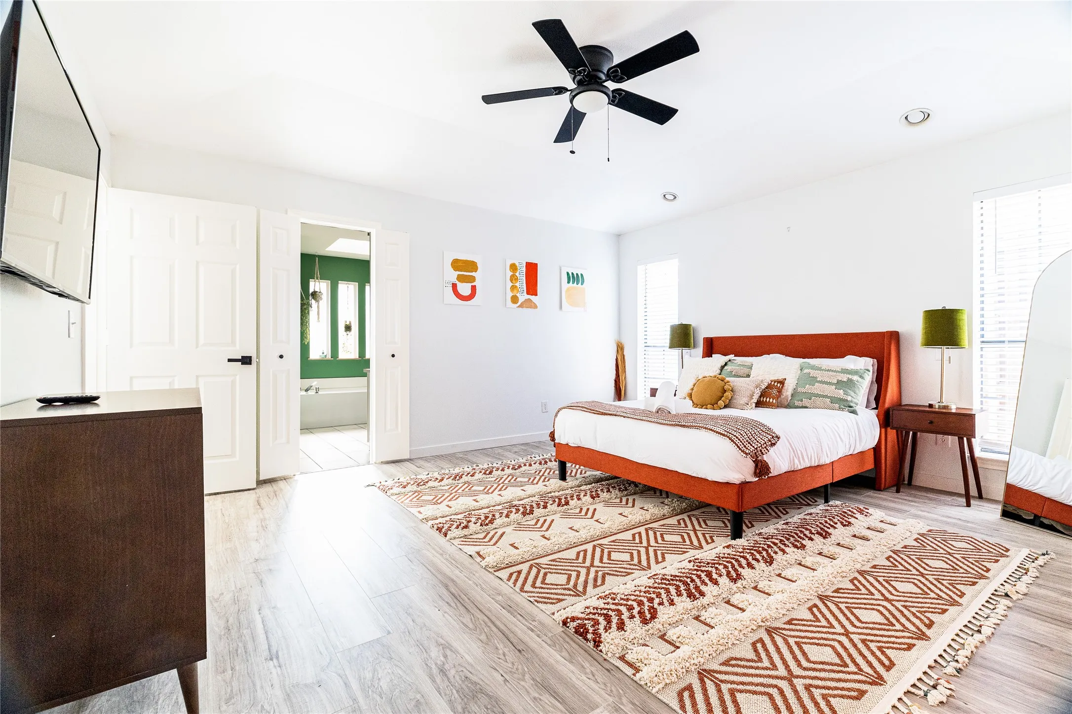 Wood-finish flooring, ceiling fan, recessed lighting, and white paneled doors