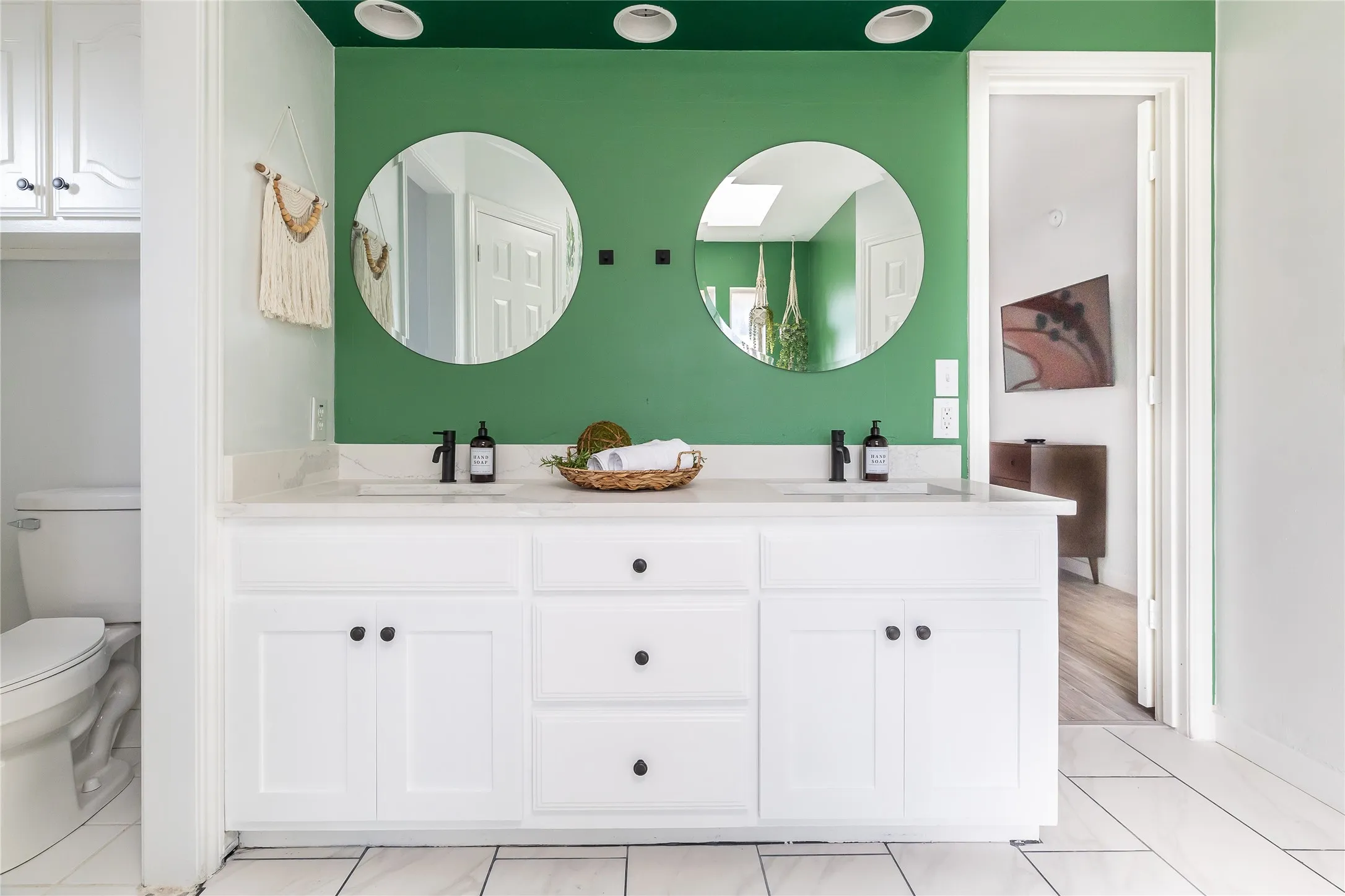 Dual vanity with a stone countertop, individual sinks, and matte black faucets