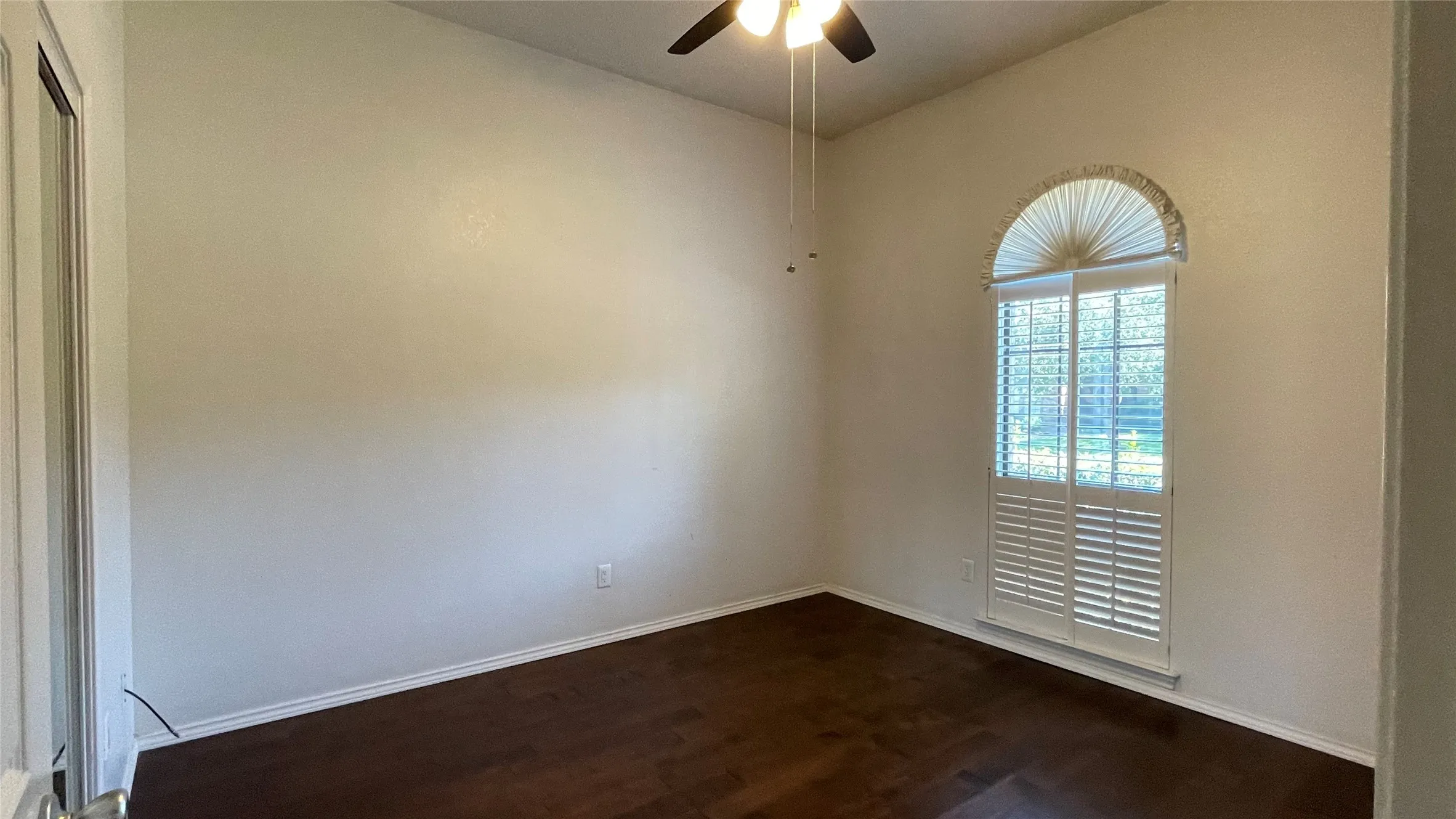 bedroom 2 with ceiling fan, closet with sliding door, Hardwood floor