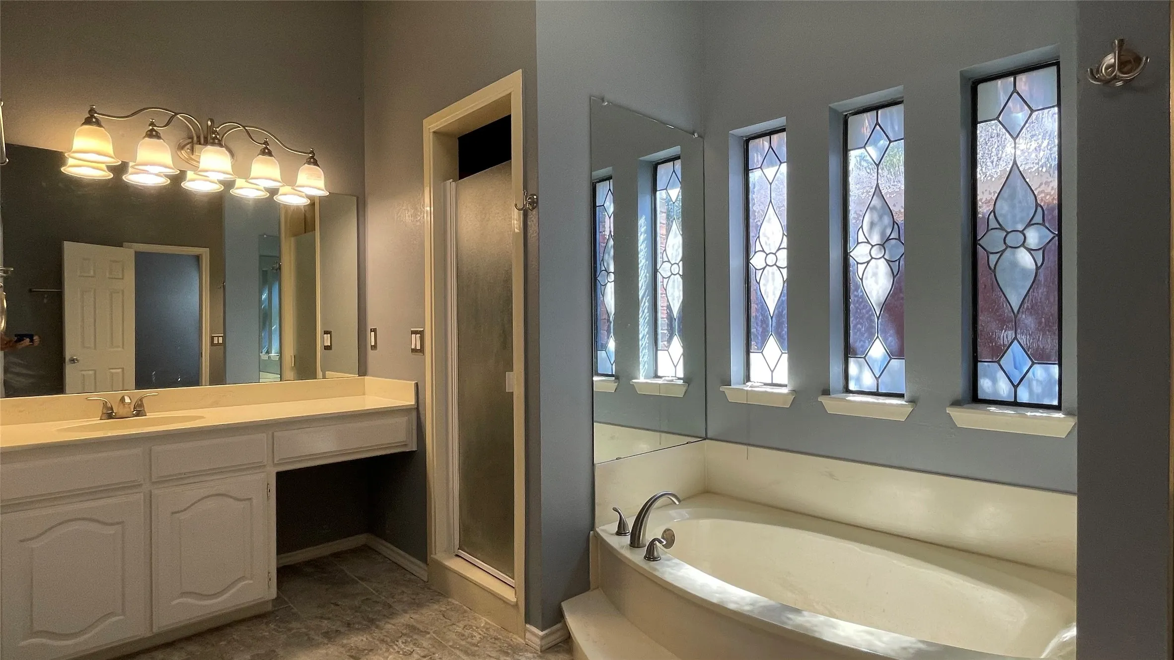 beautiful master bathroom with leaded window glasses, rectangular tile floor