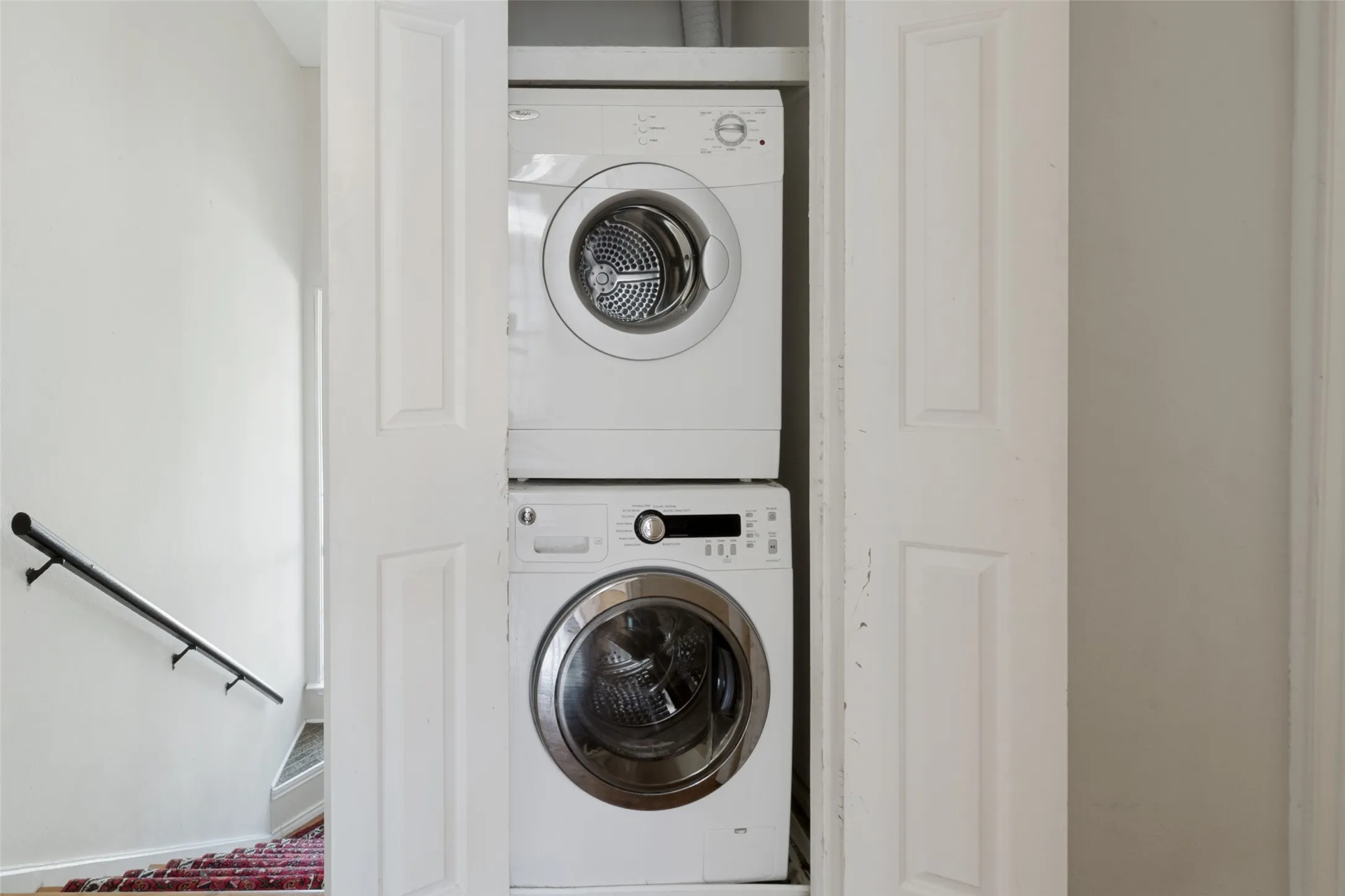 Stacked washer and dryer units within a dedicated closet