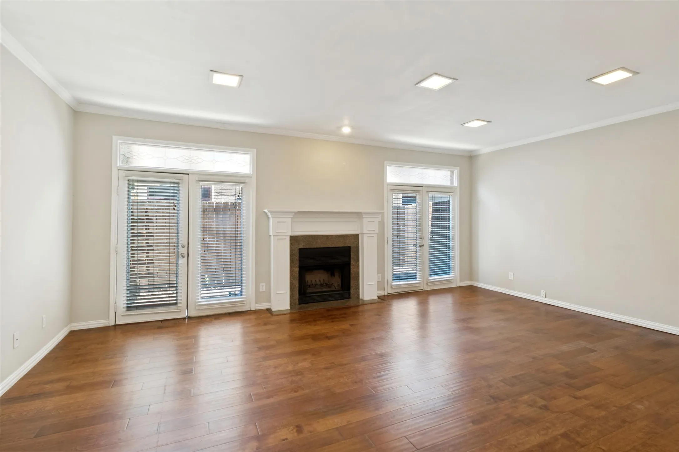 Wood floors with wood burning fireplace. Powder bath located under the stairs.