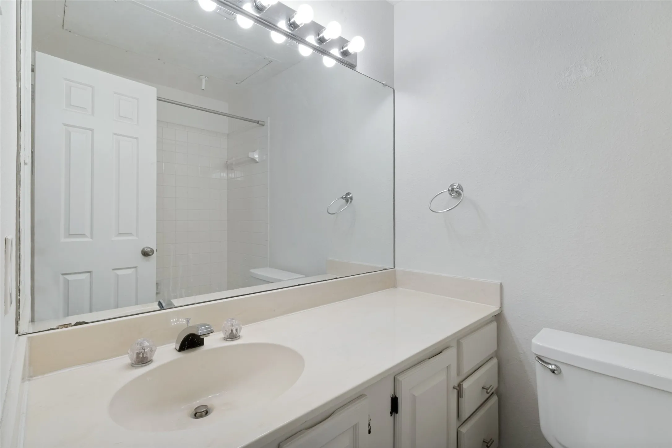 Guest Bathroom. Vanity with a single basin, a chrome faucet, and ample counter space