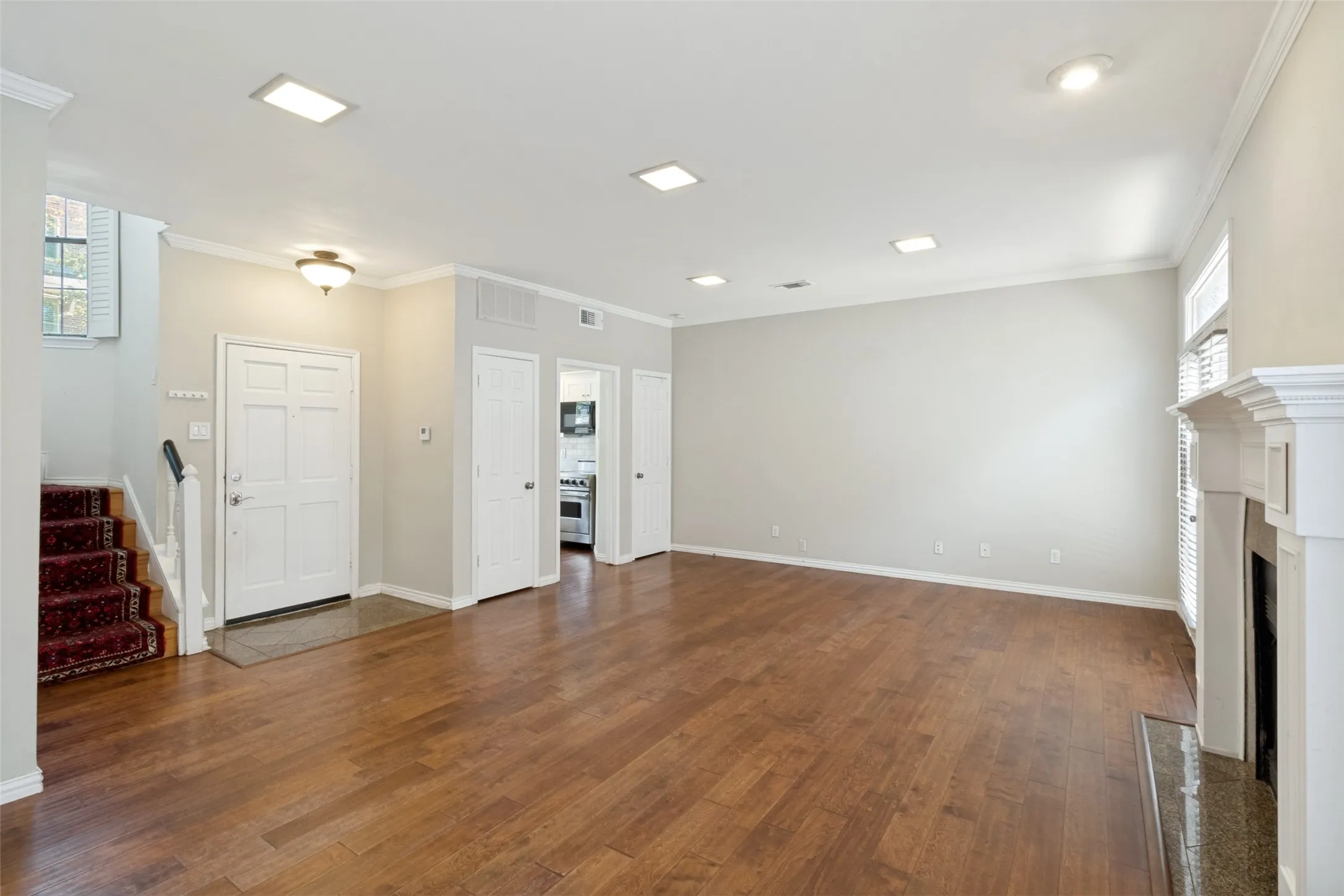 Wood floors with wood burning fireplace. Powder bath located under the stairs.