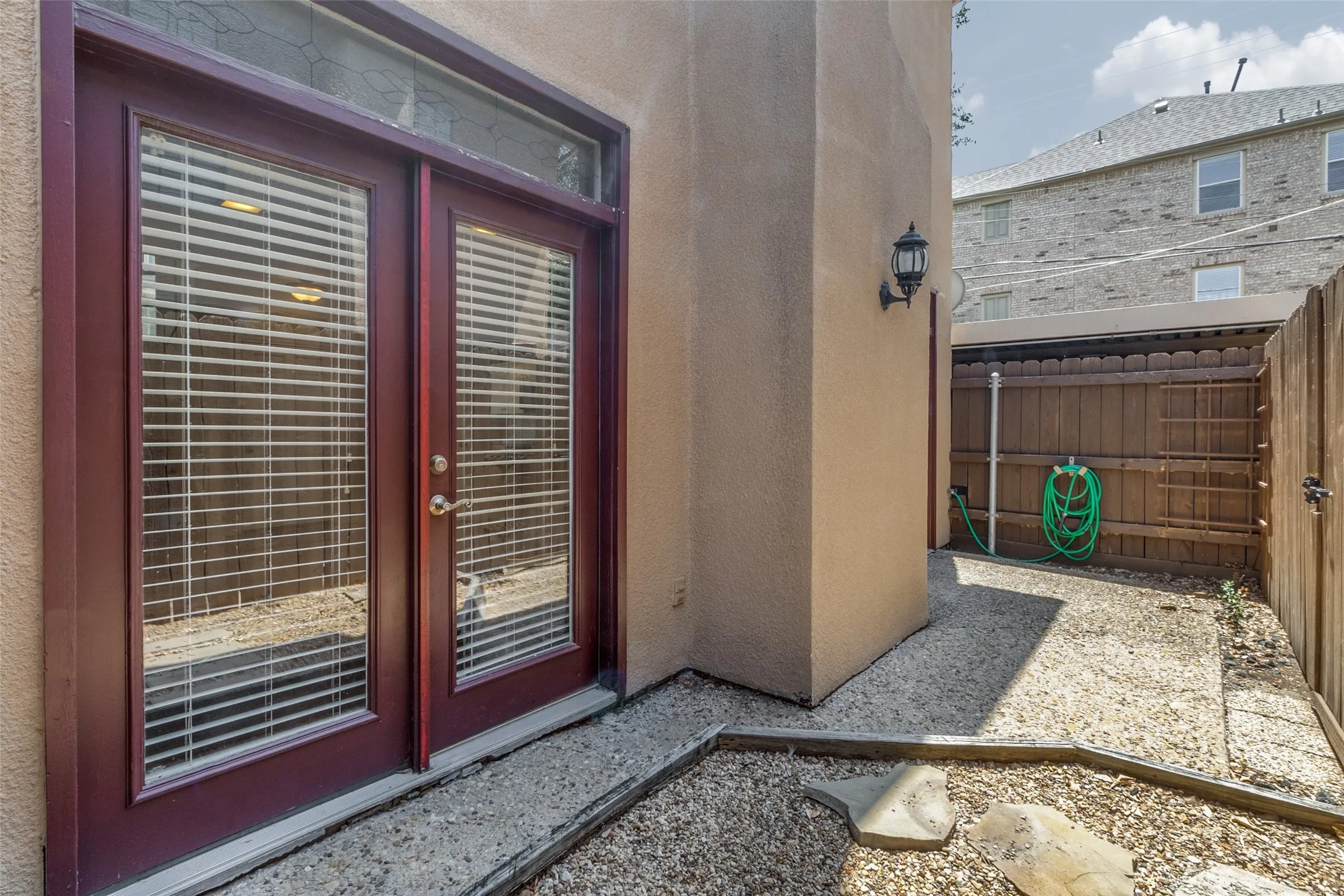 Enclosed dirt area, currently used with pea gravel.