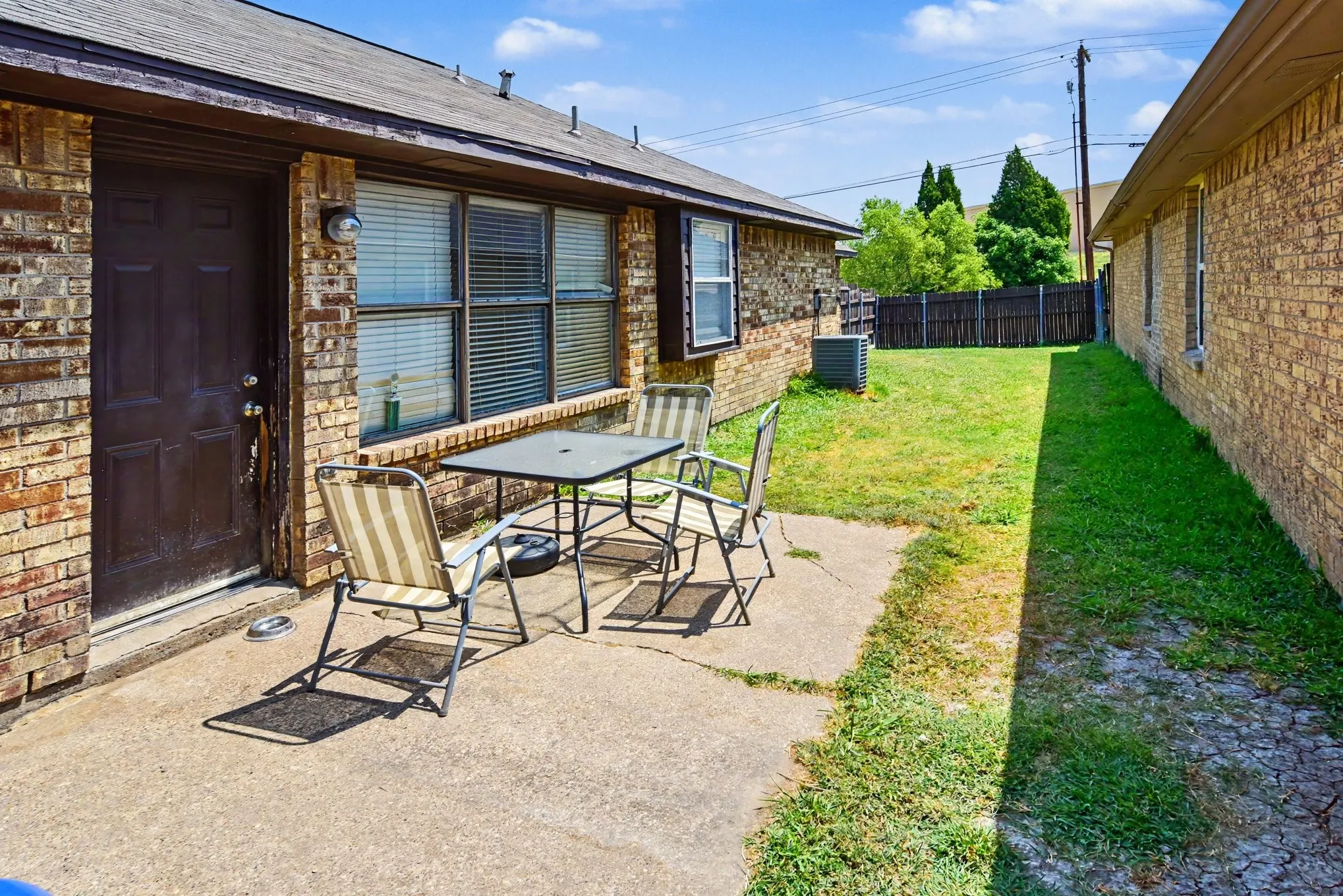 Concrete back patio space perfect for outdoor lounge seating and barbecue entertaining.