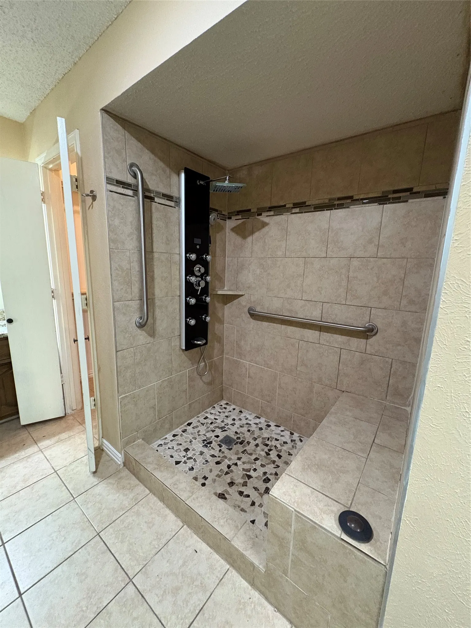 Walk-in shower with tiled walls and floor