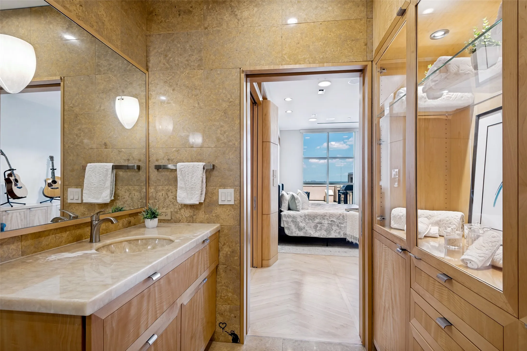 Wood-finish cabinetry and built-in storage with glass inserts