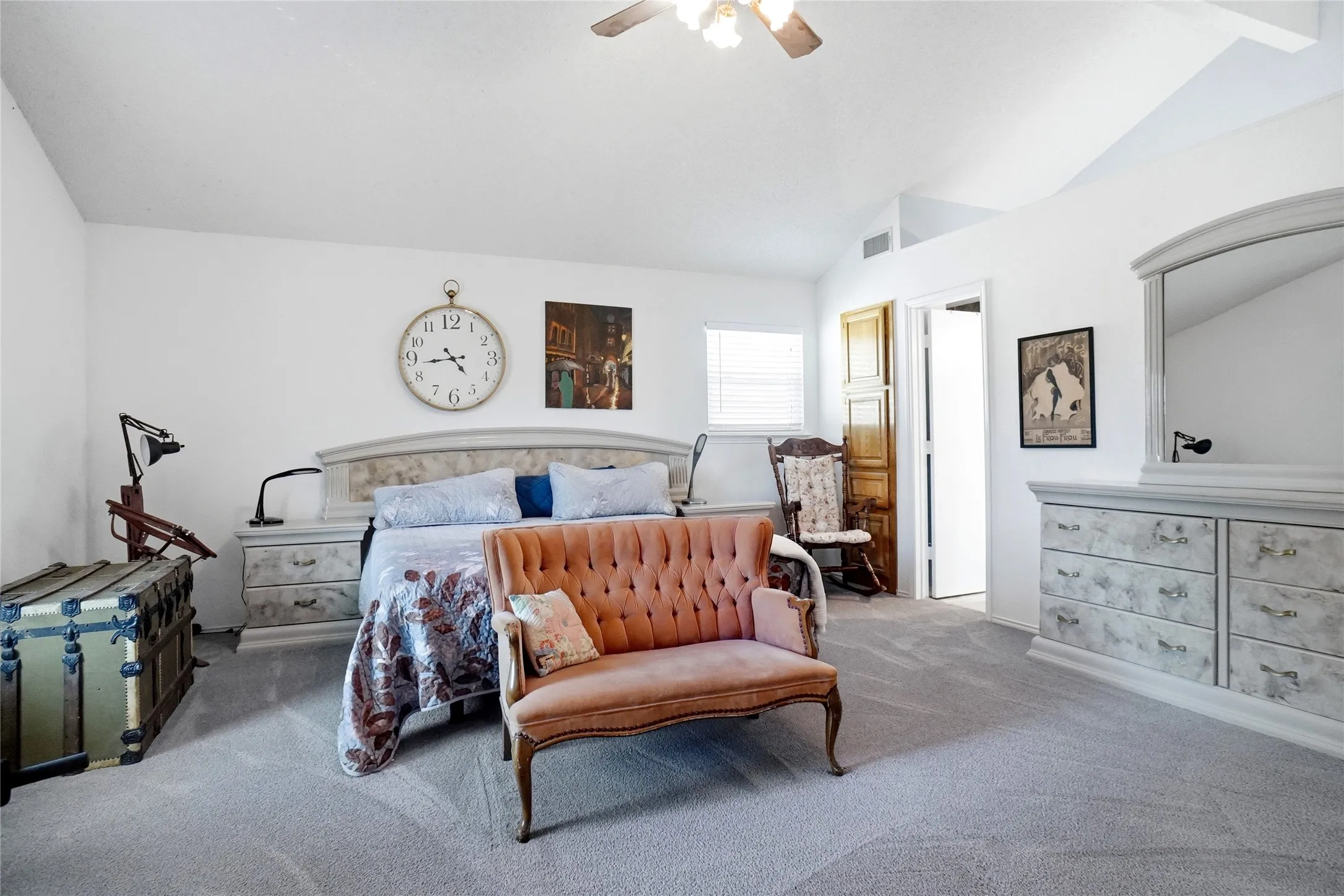 Vaulted ceiling with a ceiling fan, white walls, light-colored carpet, and a window with blinds