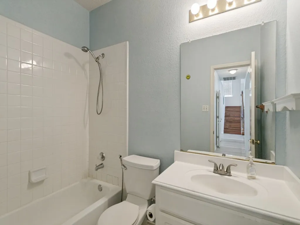 White vanity with an integrated sink and brushed nickel faucet