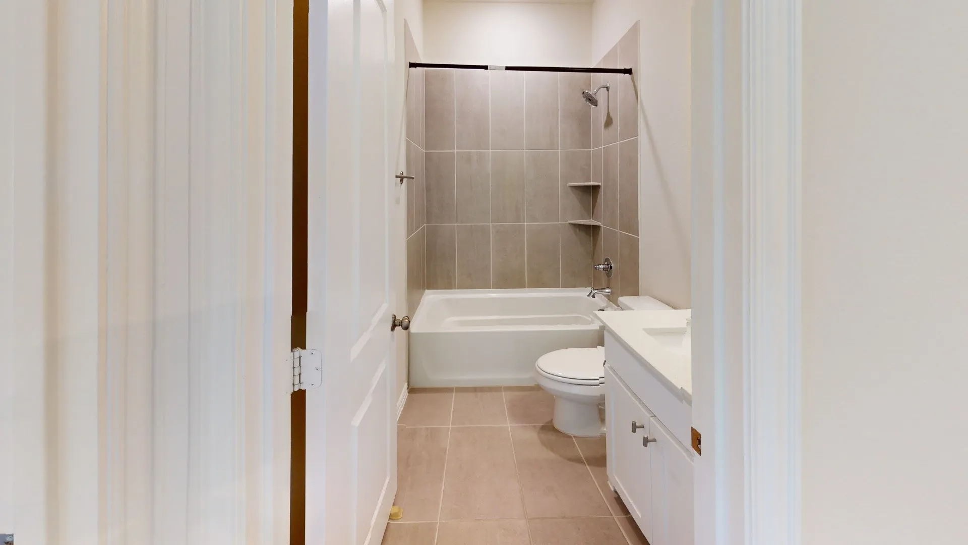 Tub/shower combination with tile surround and built-in shelving