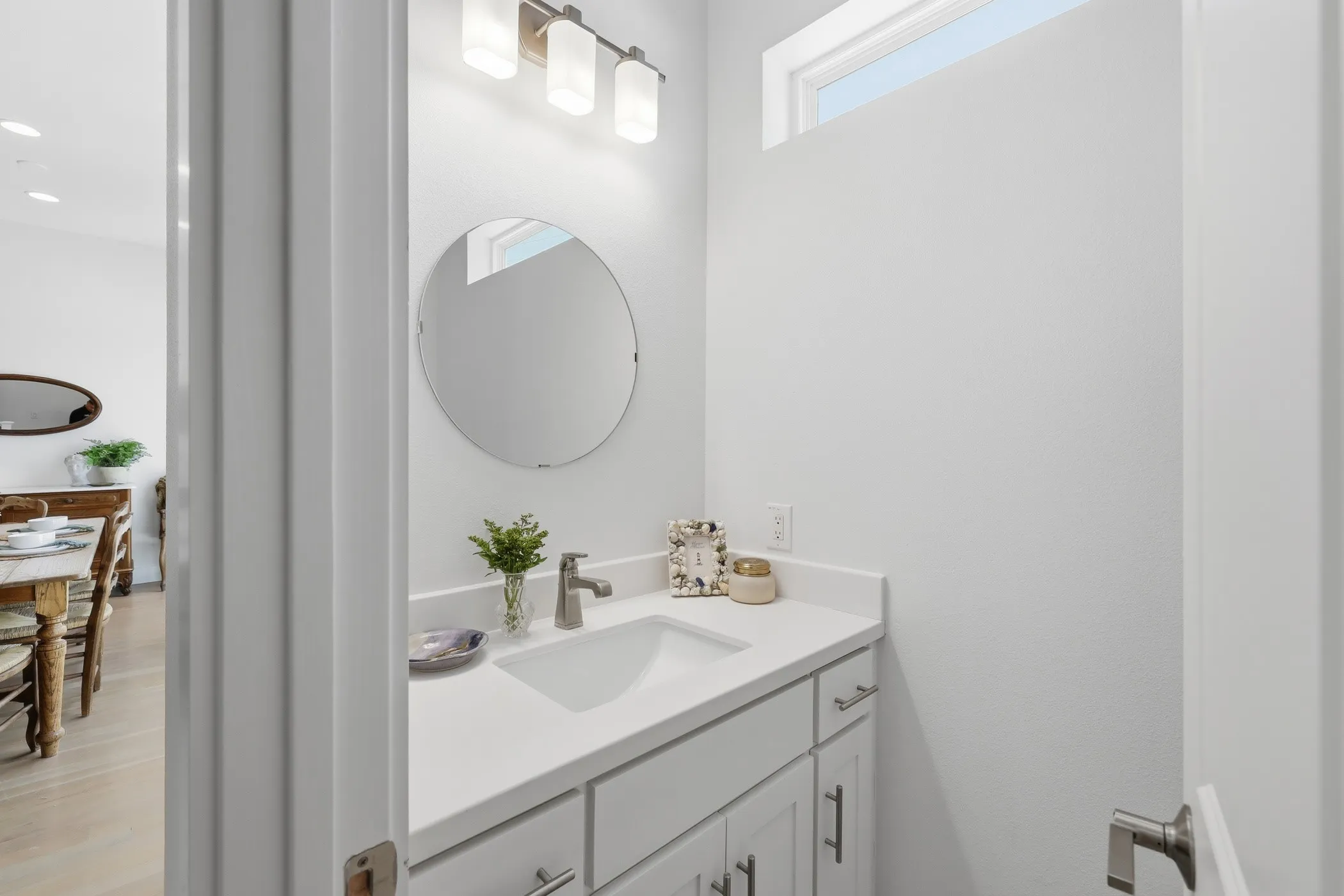 White vanity with an integrated sink and light-toned countertop