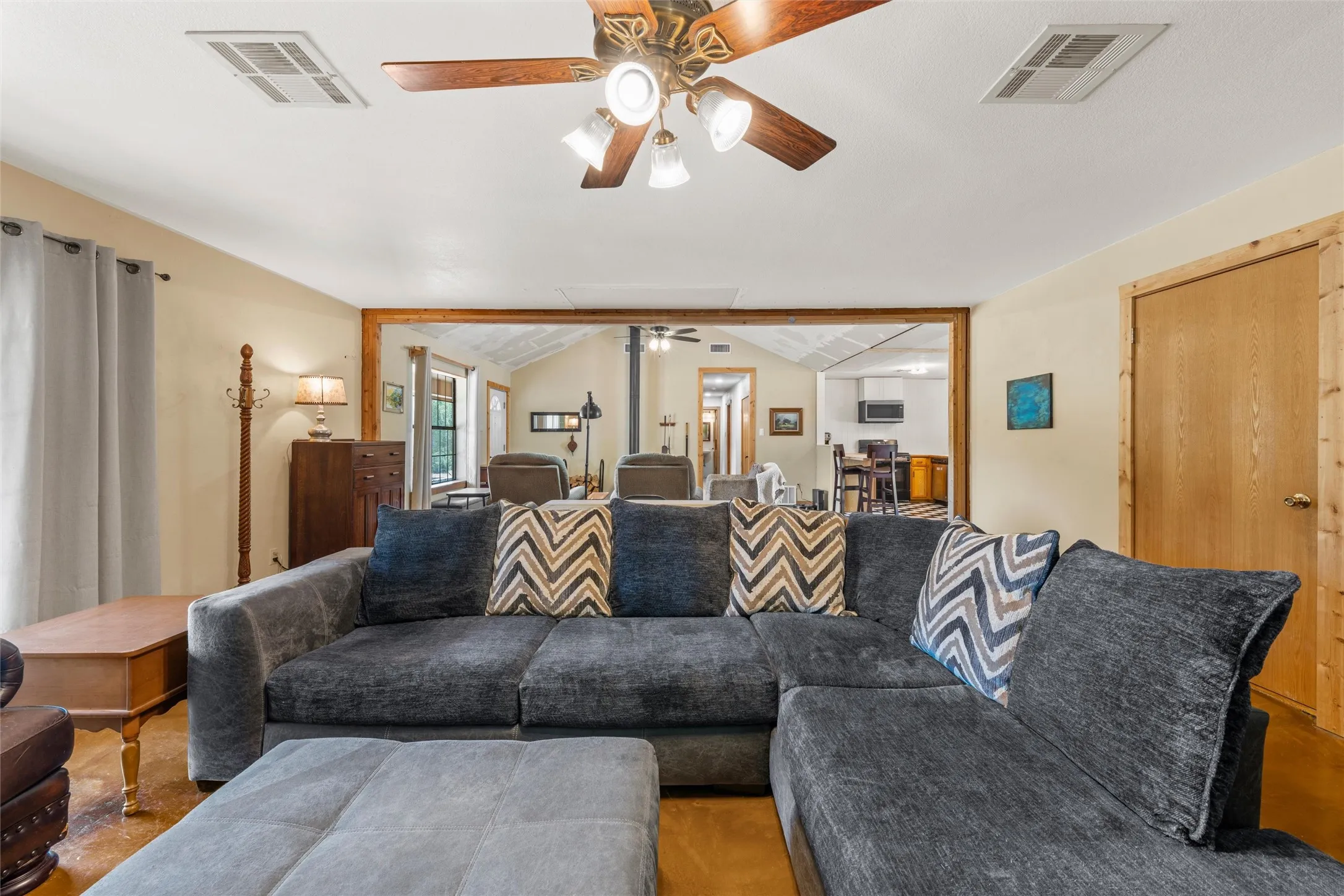 Recessed lighting, wood-finish ceiling fan, wood-trimmed doorway, durable flooring, neutral wall tones