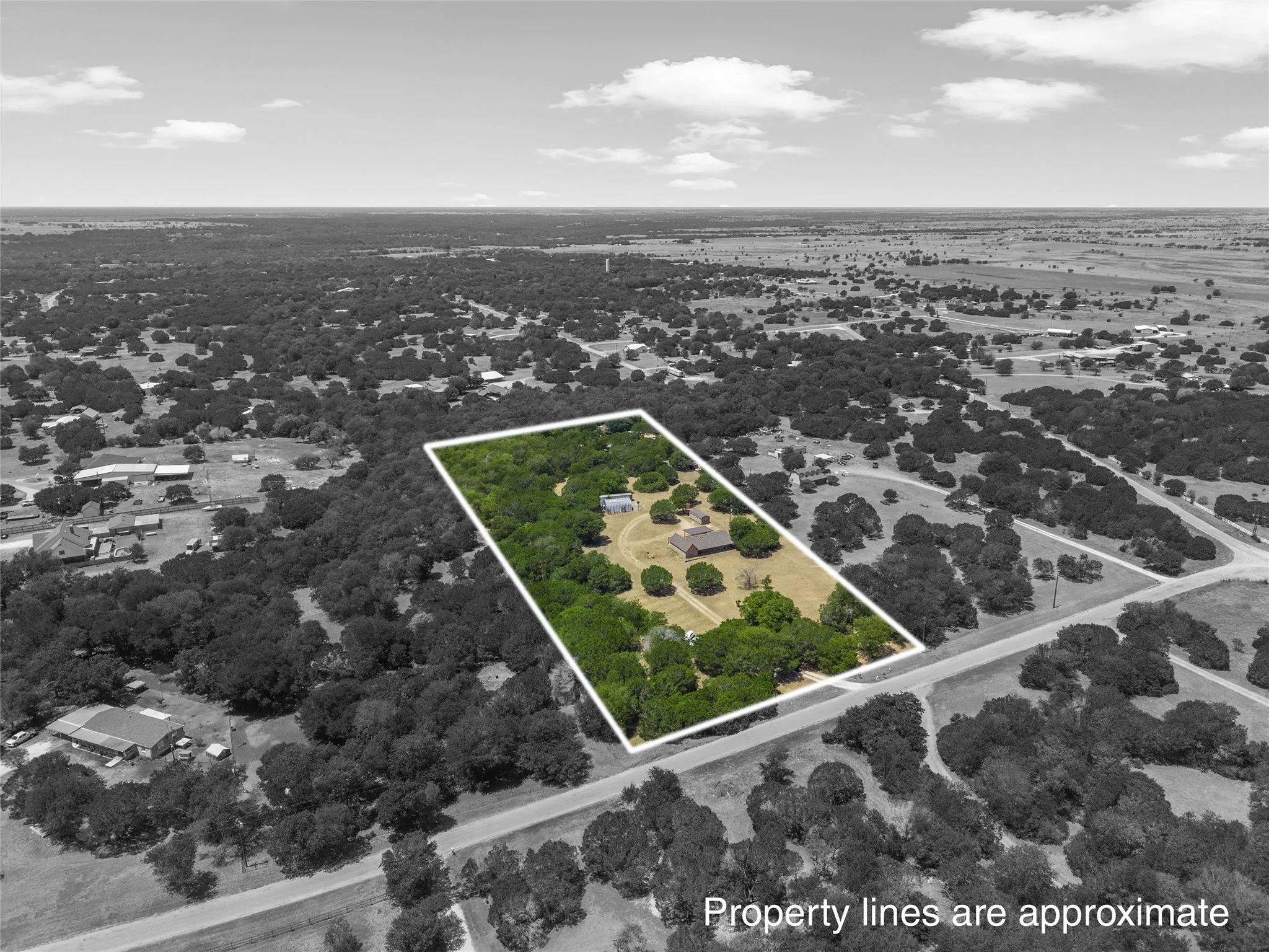 Expansive lot with mature trees and a residential structure