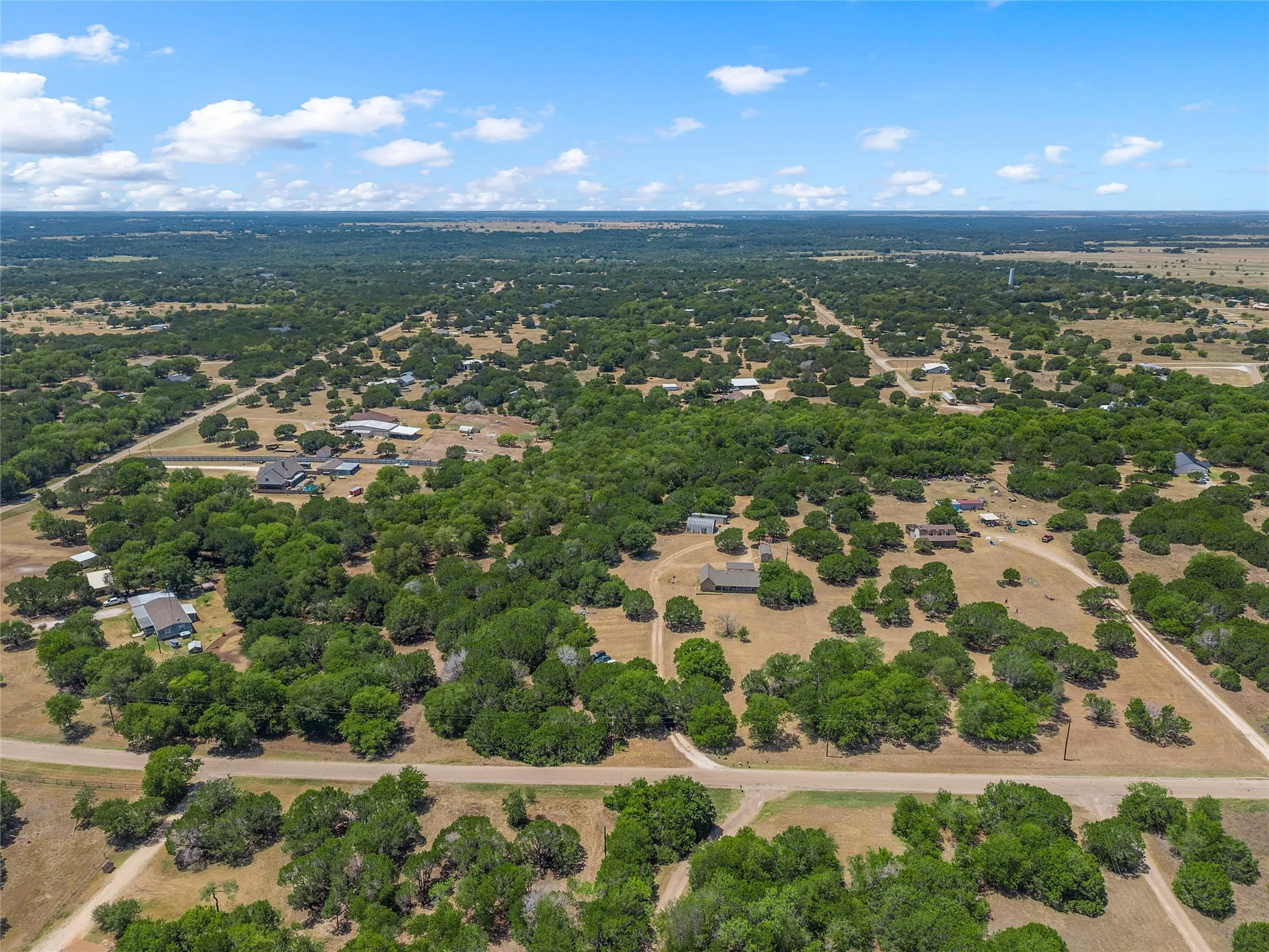 Expansive land featuring numerous mature trees and open clearings