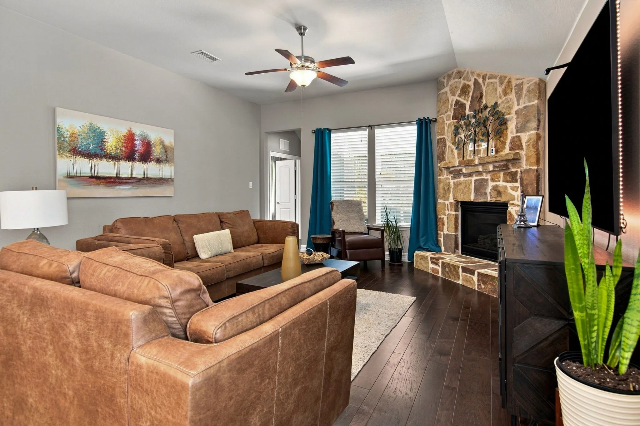 Cozy corner rock fireplace with hearth just adds so much ambiance!