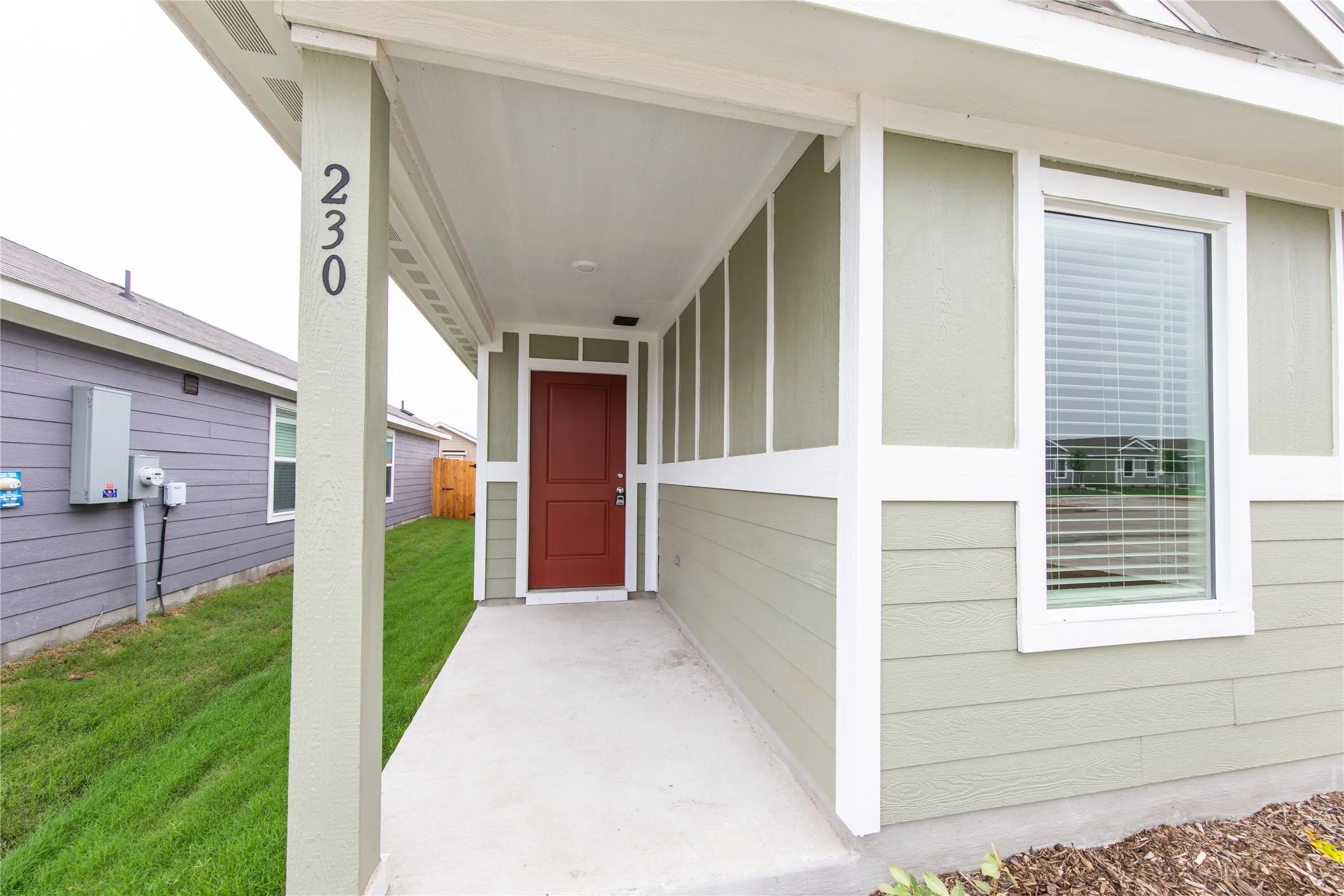 View of exterior entry featuring a lawn