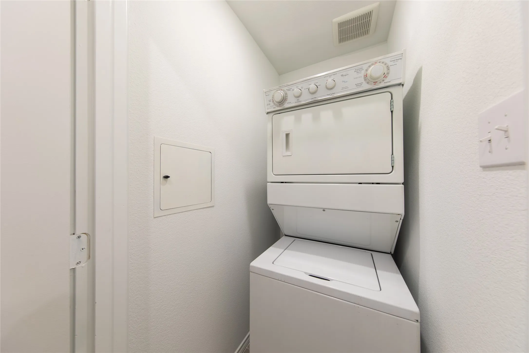 Washroom featuring stacked washer and dryer