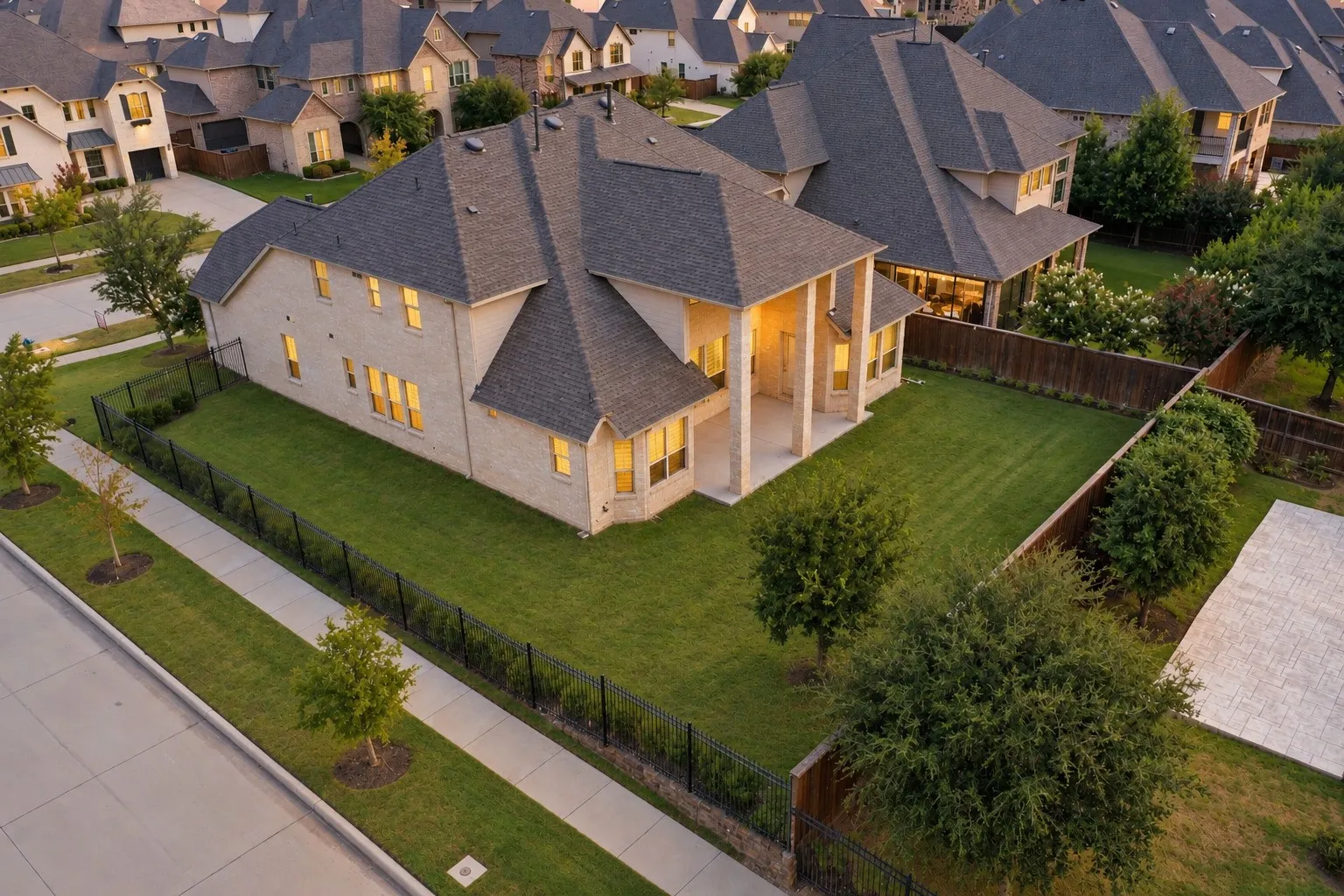 Light brick exterior with a dark shingle roof
