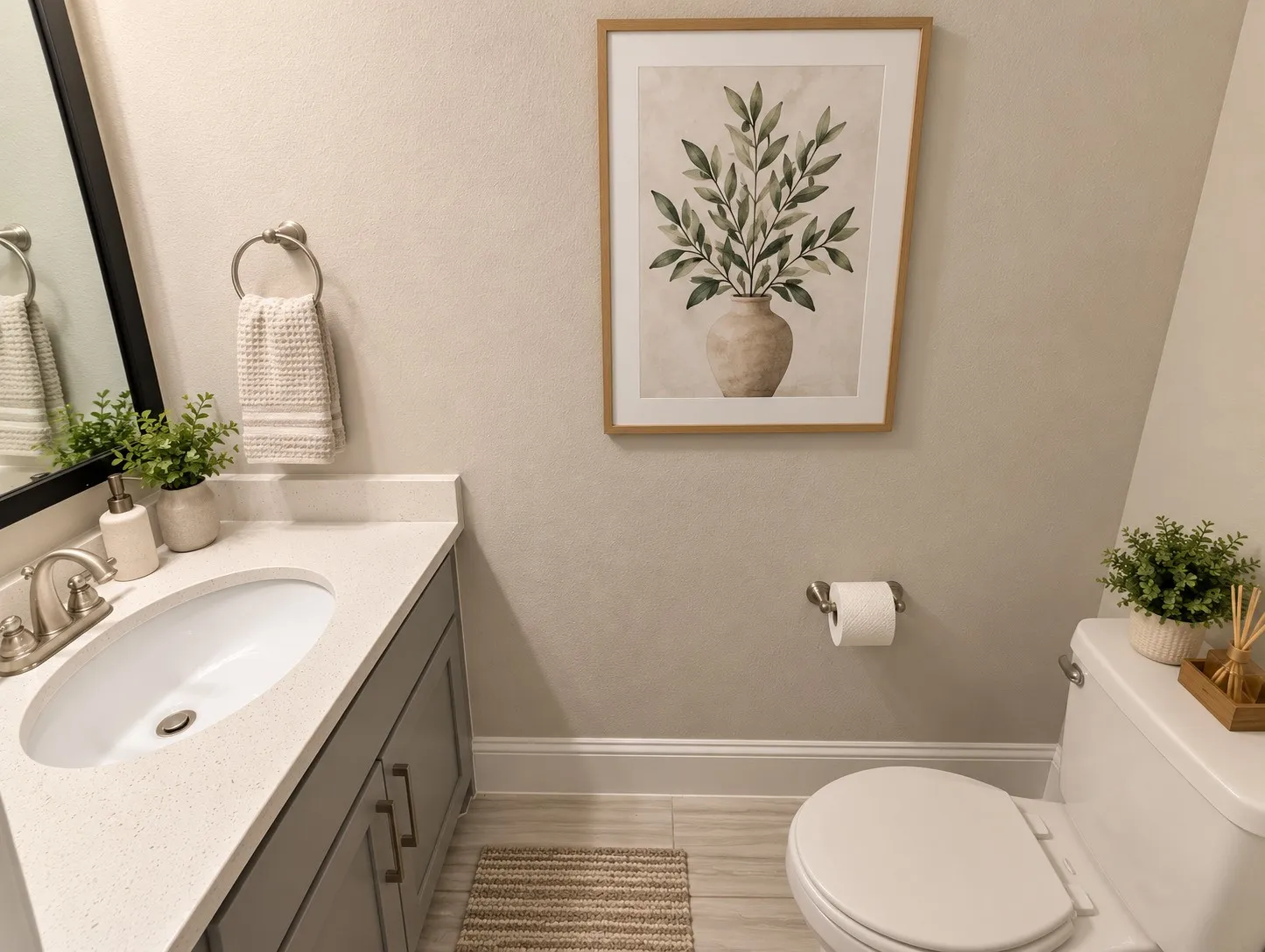 Vanity with an undermount sink, a light-colored countertop, and gray cabinetry with brushed nickel hardware