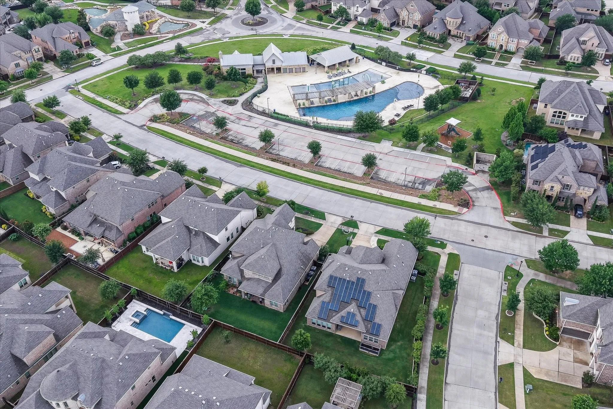 Community featuring a swimming pool, clubhouse, and green spaces