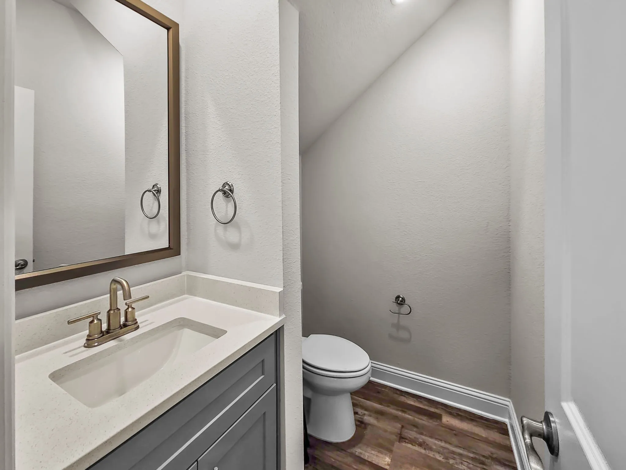 Vanity with integrated sink, quartz-finish countertop, and brushed nickel hardware