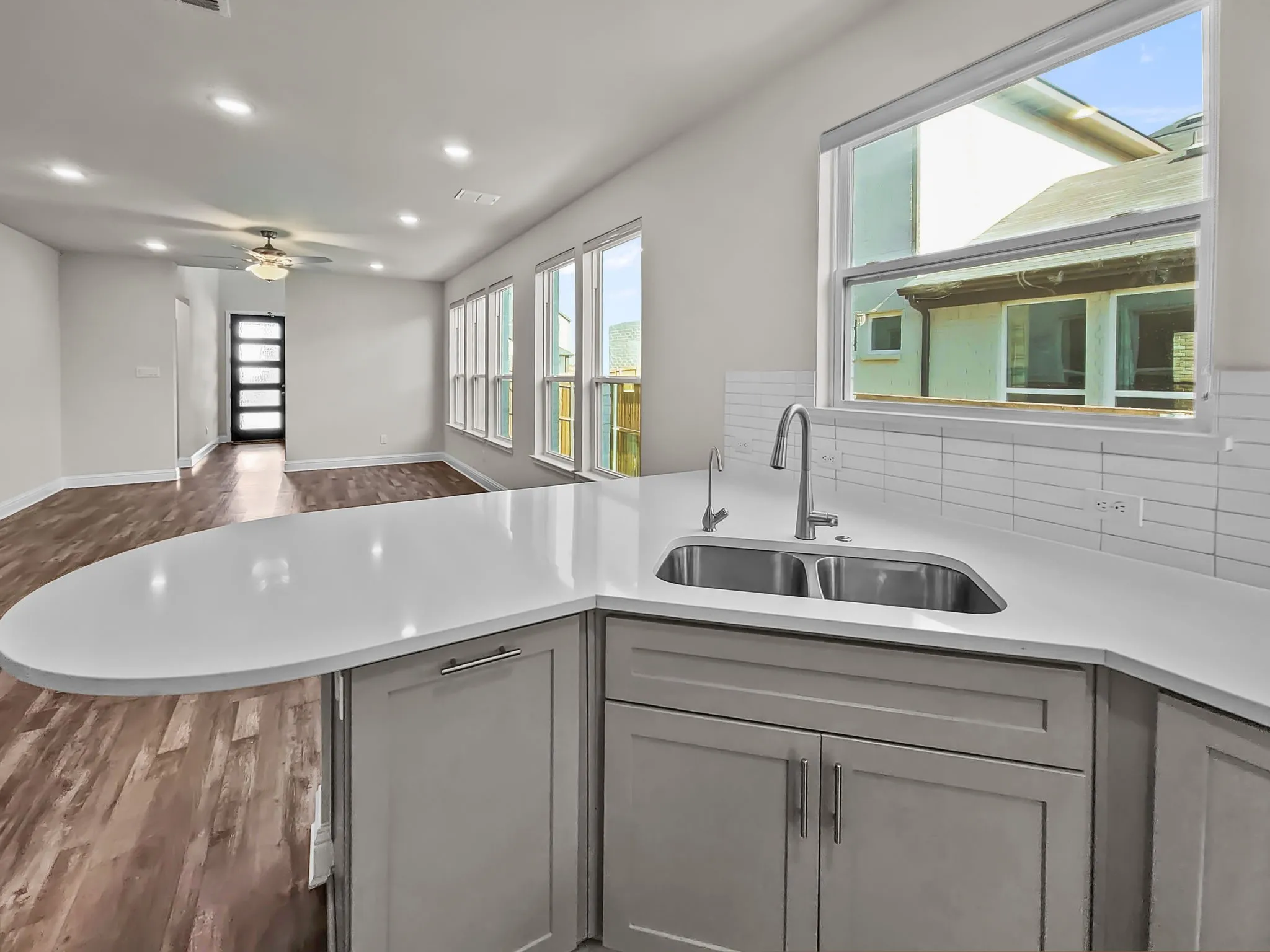Kitchen island with a white countertop and undermount double-basin sink