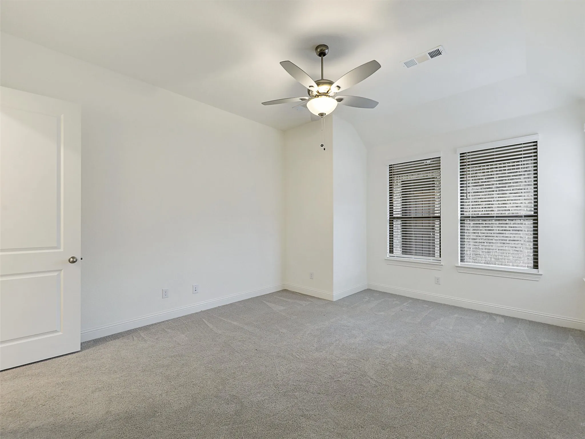 Neutral carpet flooring with white walls