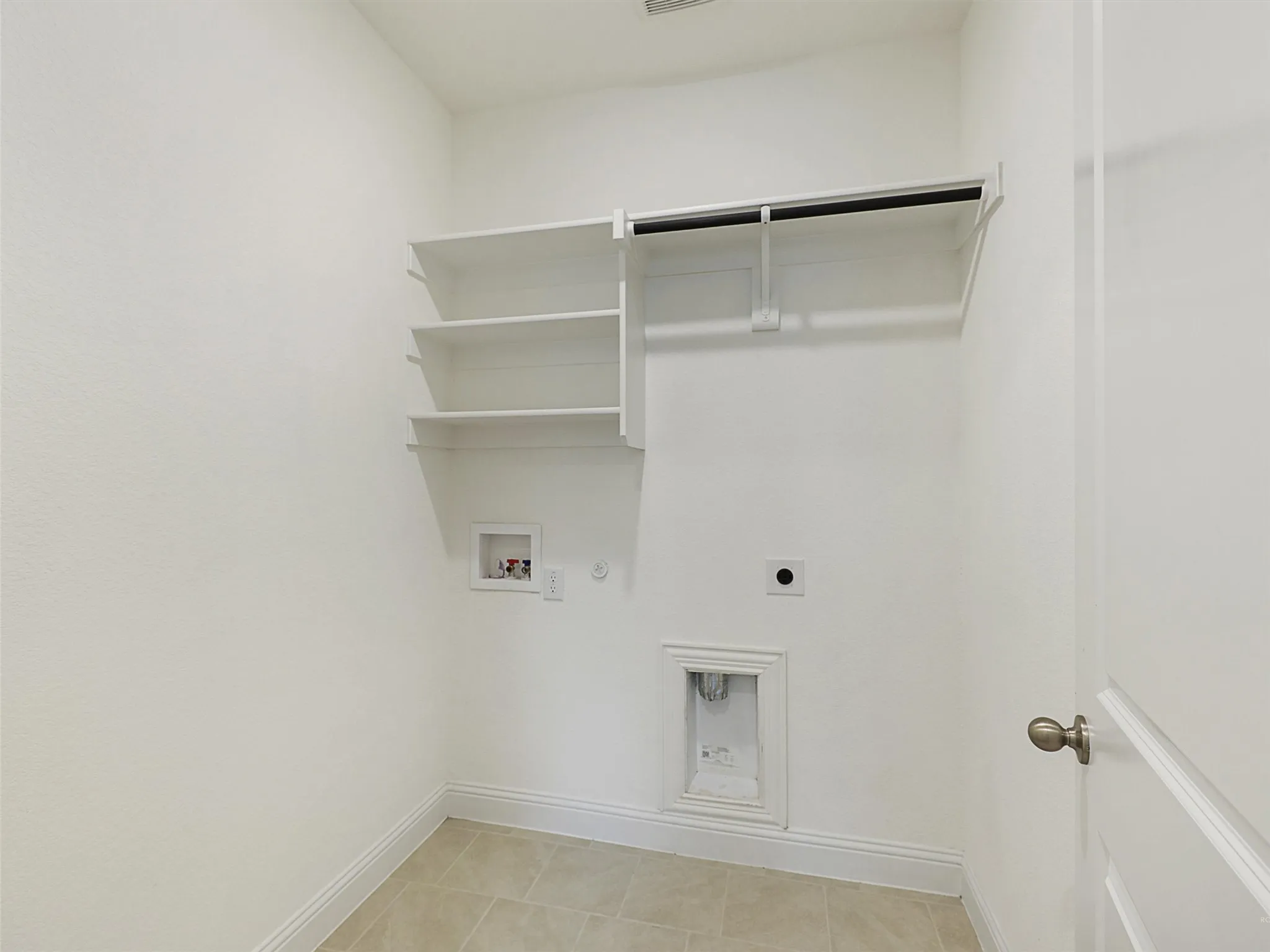 Tile flooring with built-in shelving, a clothes rod, and utility hookups