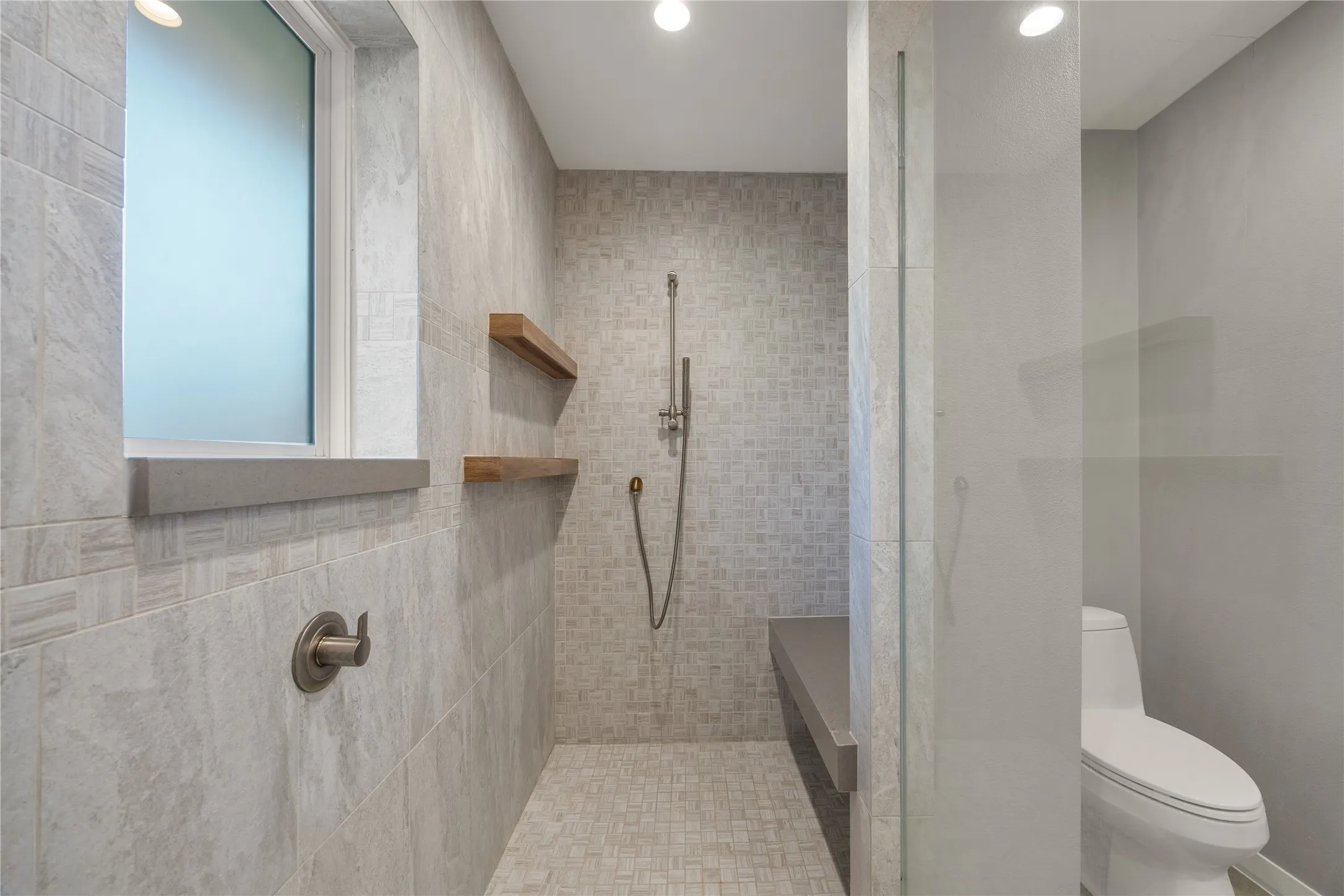 Huge shower with teak shelves