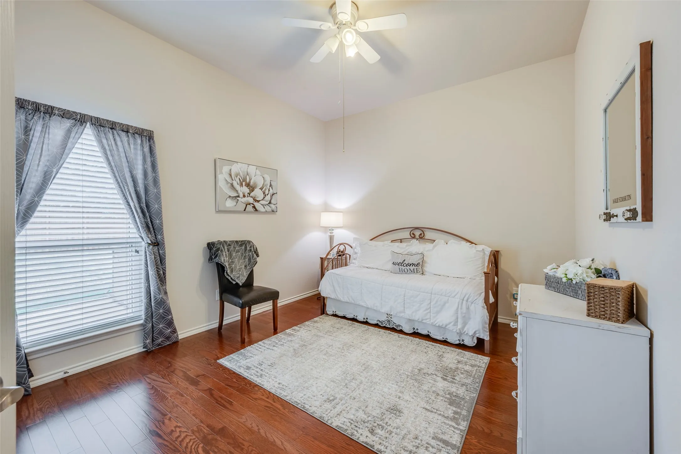 Vaulted ceiling with ceiling fan, wood-finish flooring, and a window with blinds