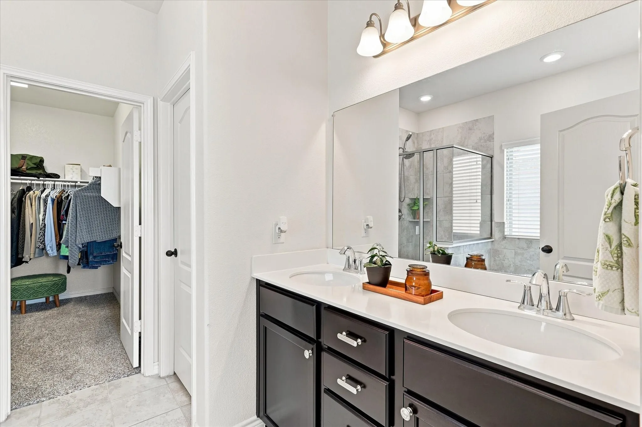 Dual vanity with dark wood-finish cabinetry and light-toned countertops