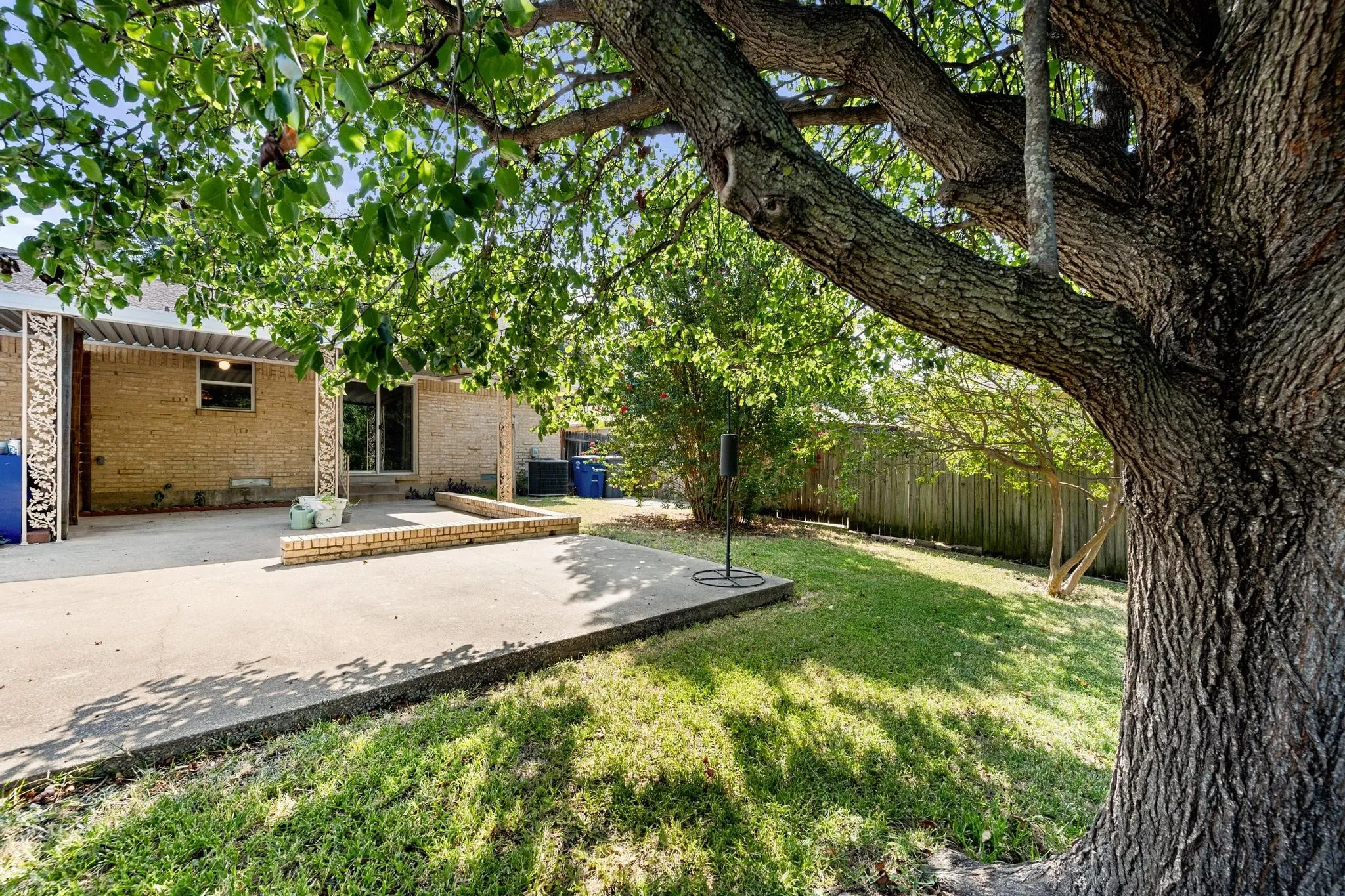 Expansive concrete patio with brick retaining wall