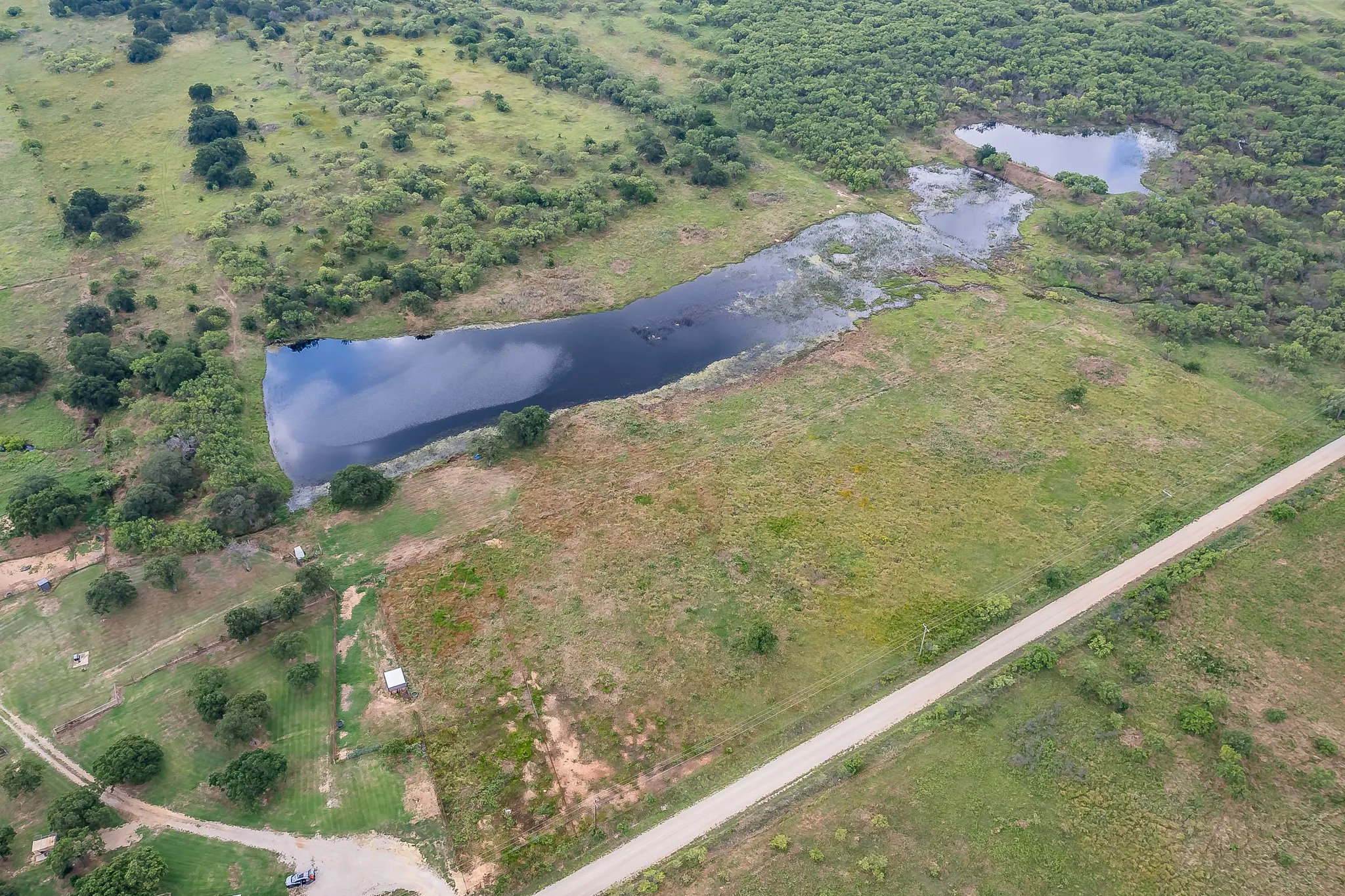 Birds eye view of property with a water view