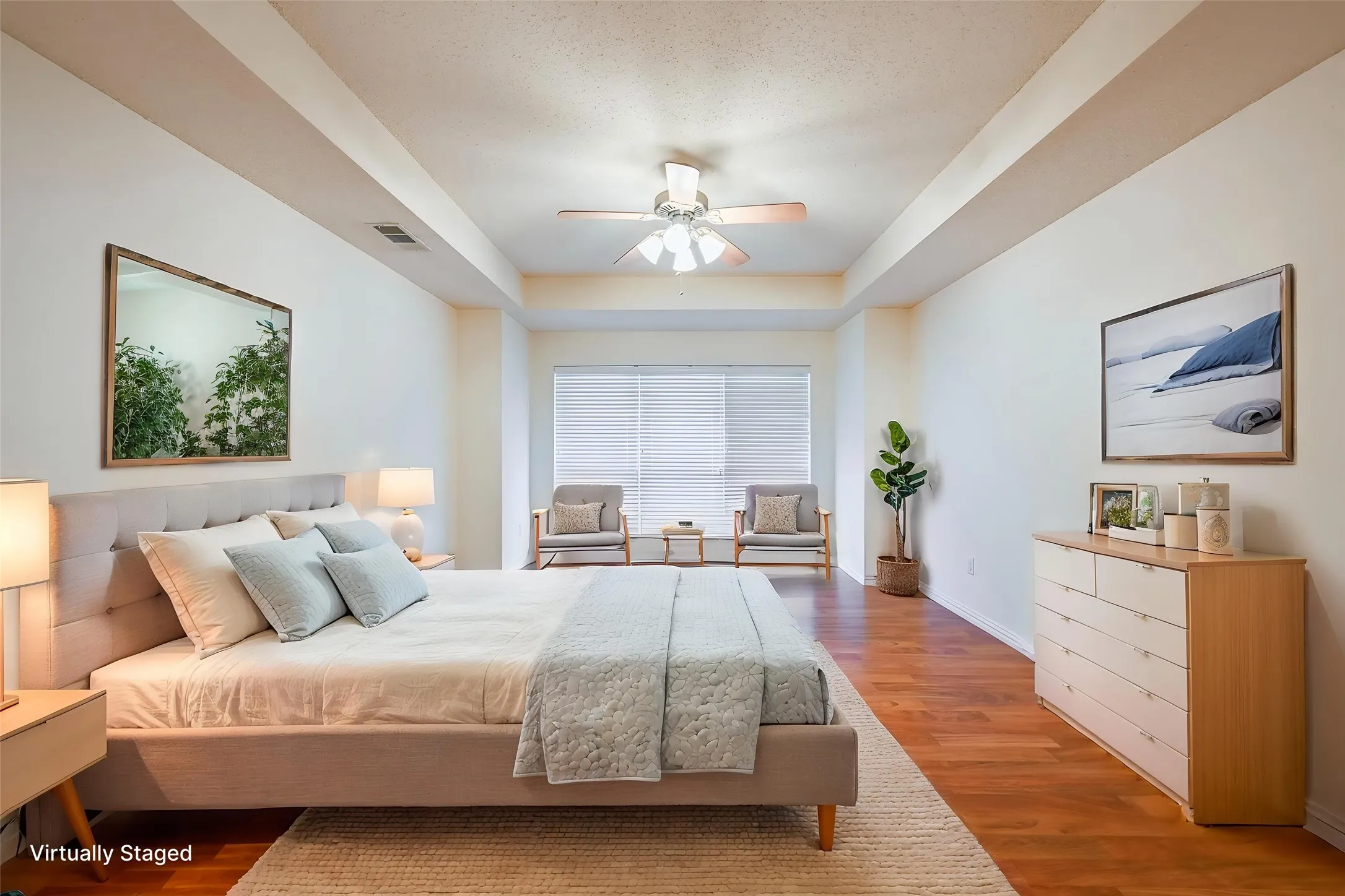 Tray ceiling with a ceiling fan, wood-finish flooring, and white window blinds