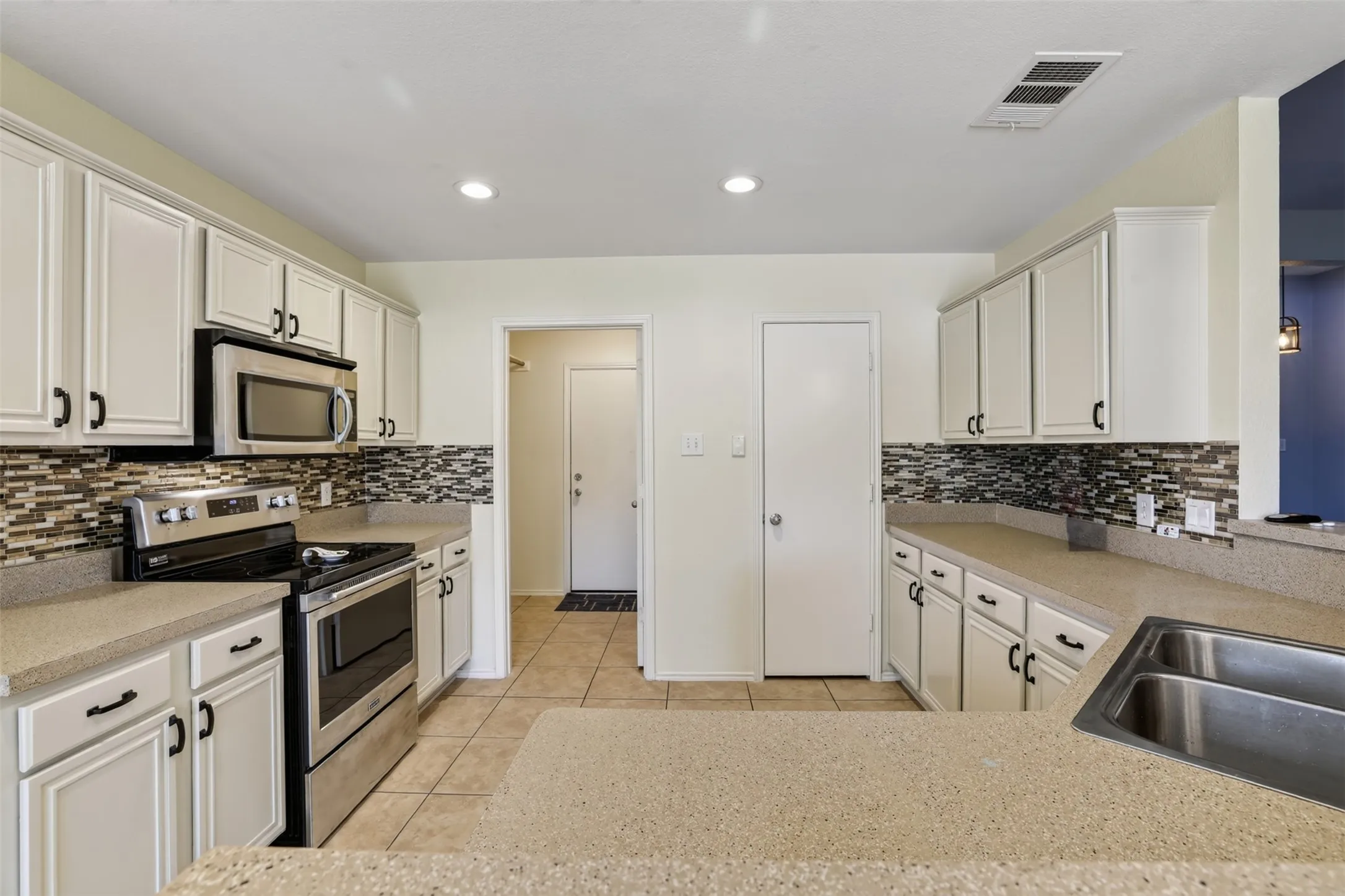 Stainless appliances and a nice-sized pantry in your open kitchen