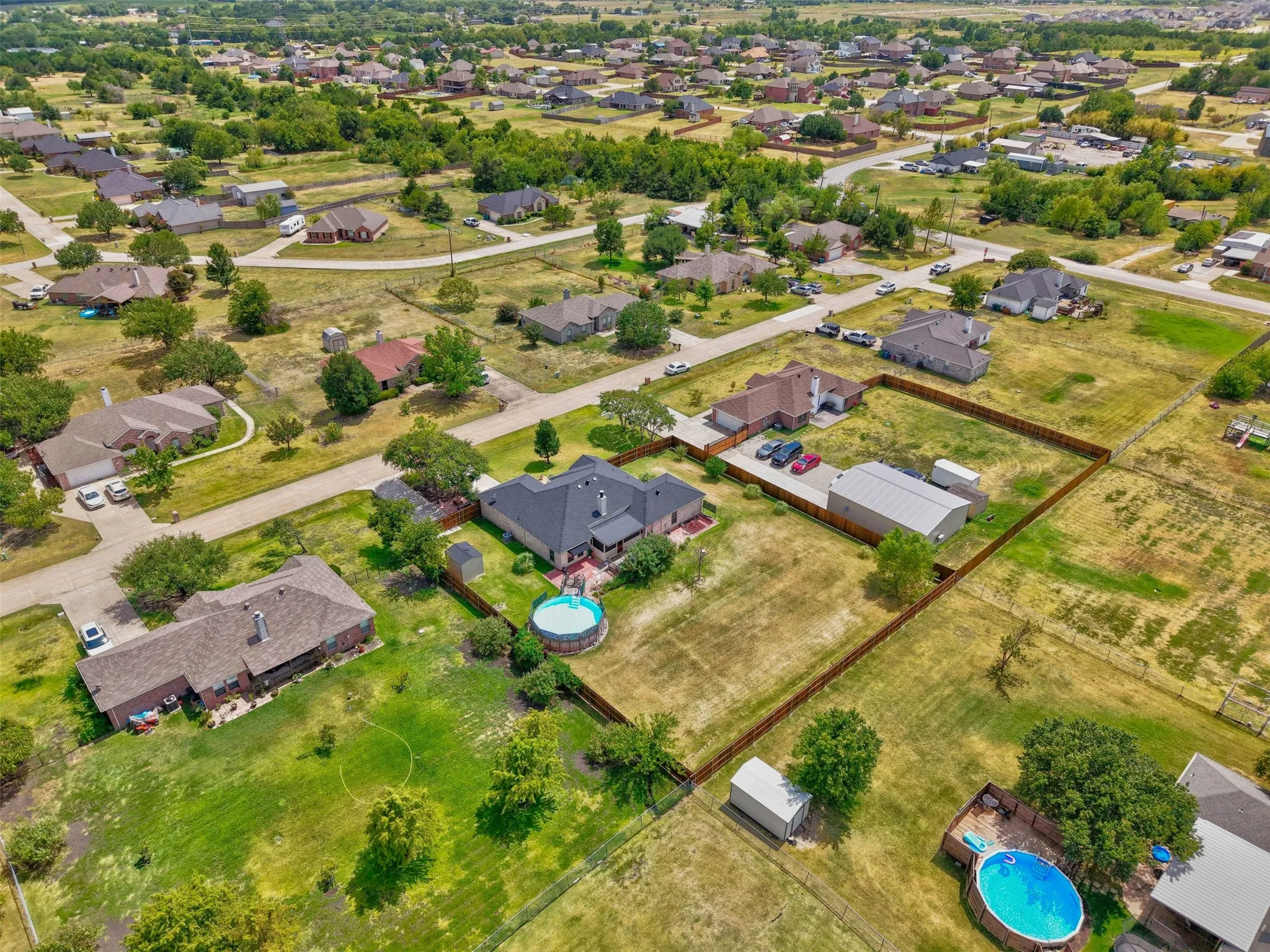 Expansive property featuring a main residence with a new class 3 roof, a secondary structure, and a private perimeter fence
