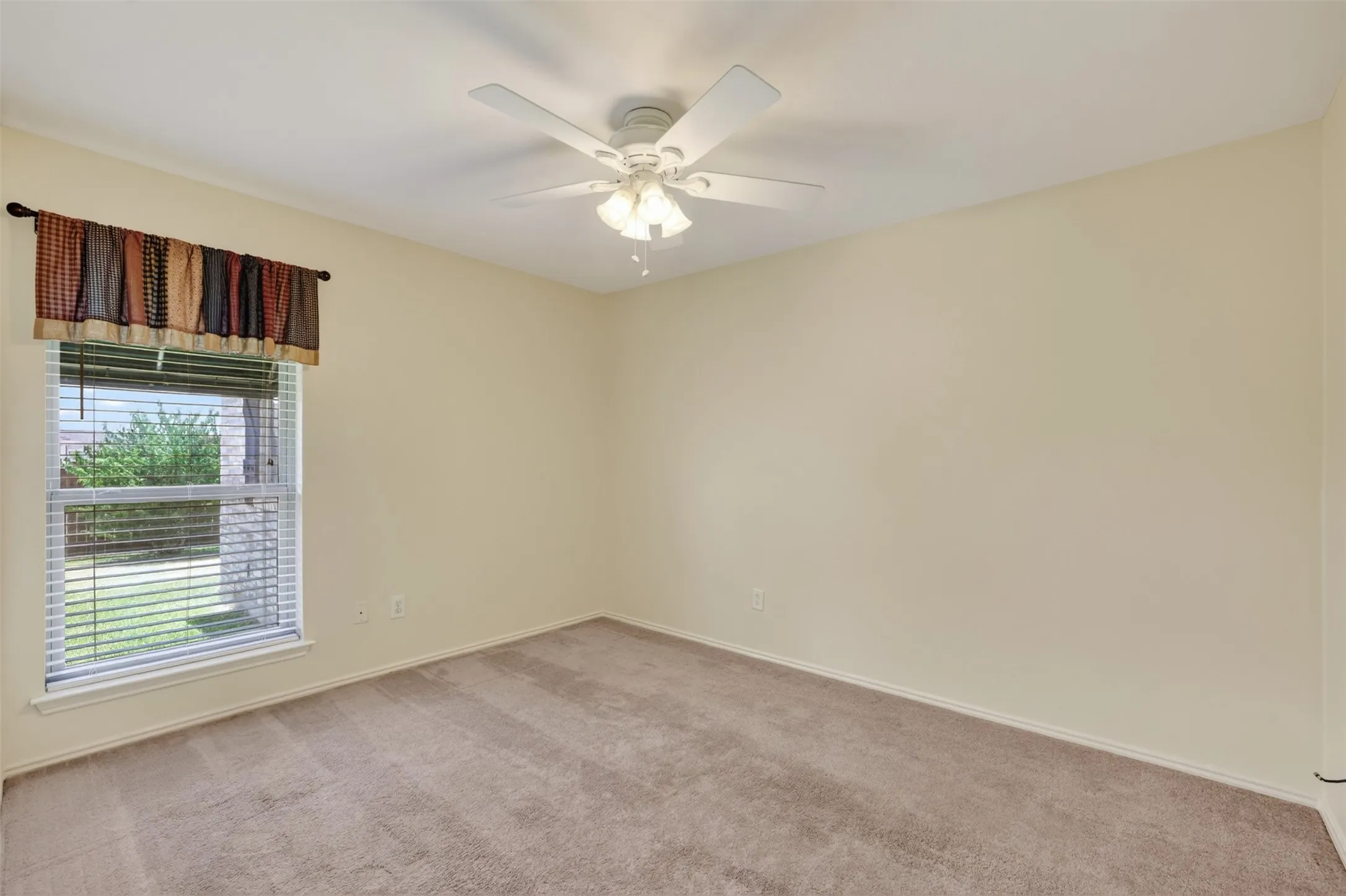 Bedroom #4 with neutral-toned walls, carpeted flooring, and a ceiling fan with integrated lighting