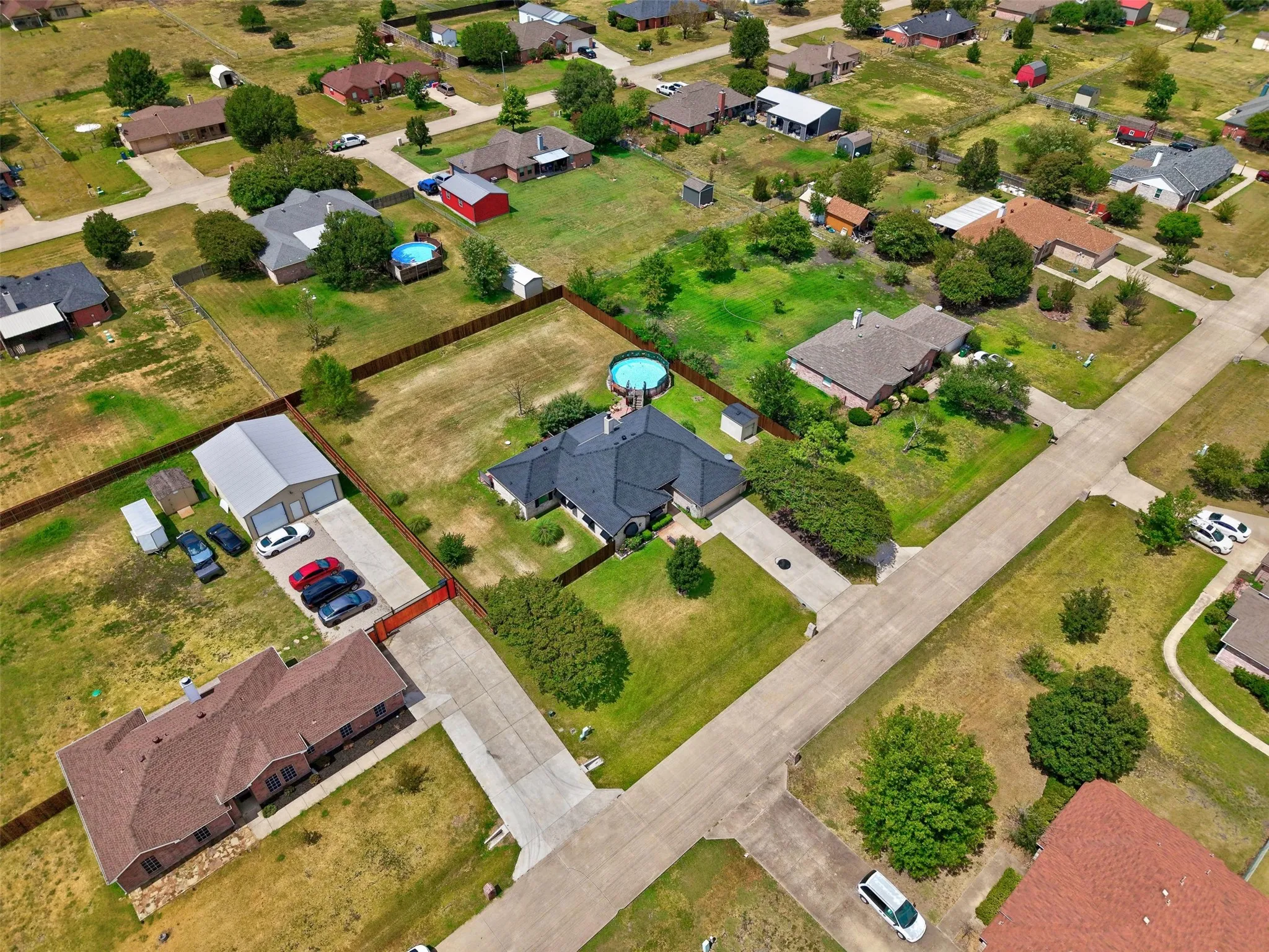 Generous lot with a private backyard, featuring a built-in pool and mature trees