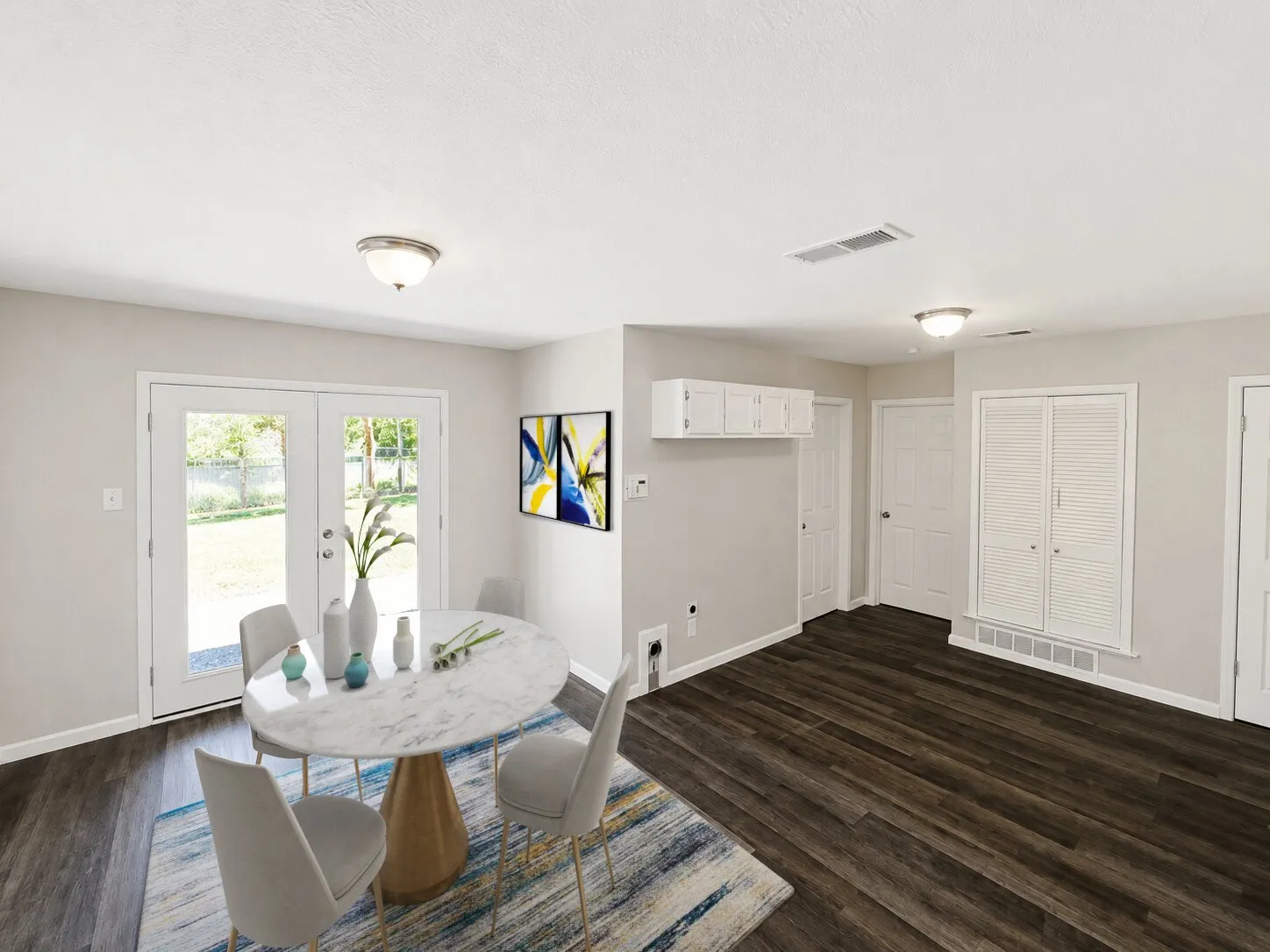 Virtually staged
White French doors, wood-finish flooring, white built-in storage, and flush-mount lighting fixtures