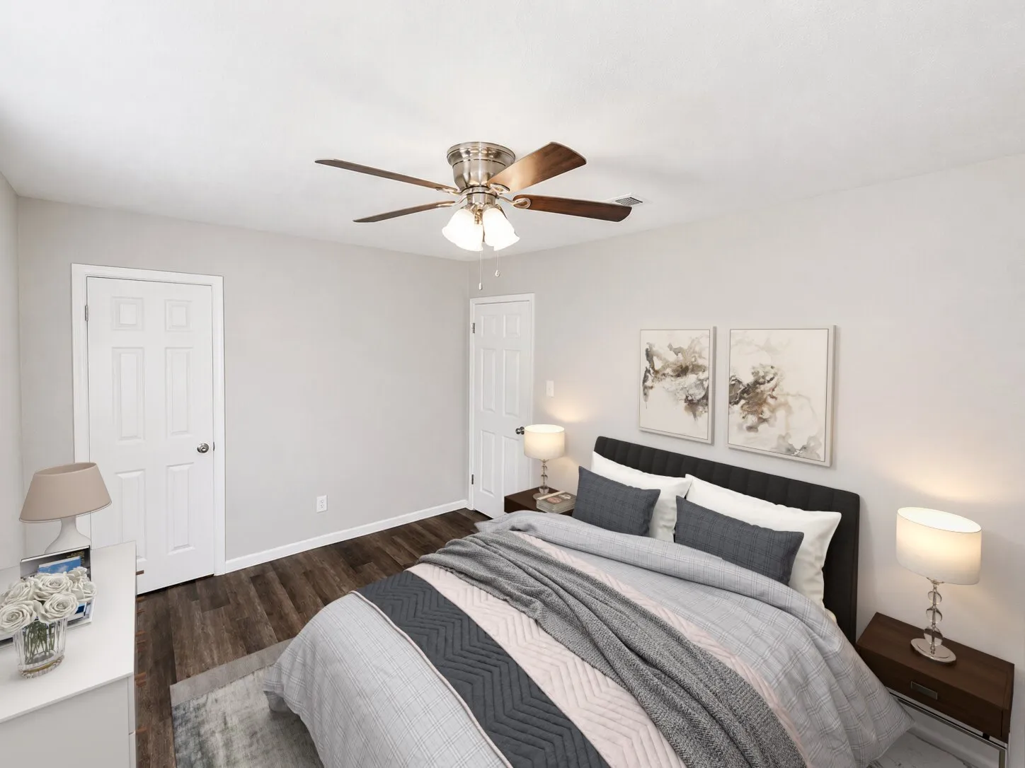 Virtually staged
Wood-finish flooring, white paneled doors, and a ceiling fan with integrated lighting