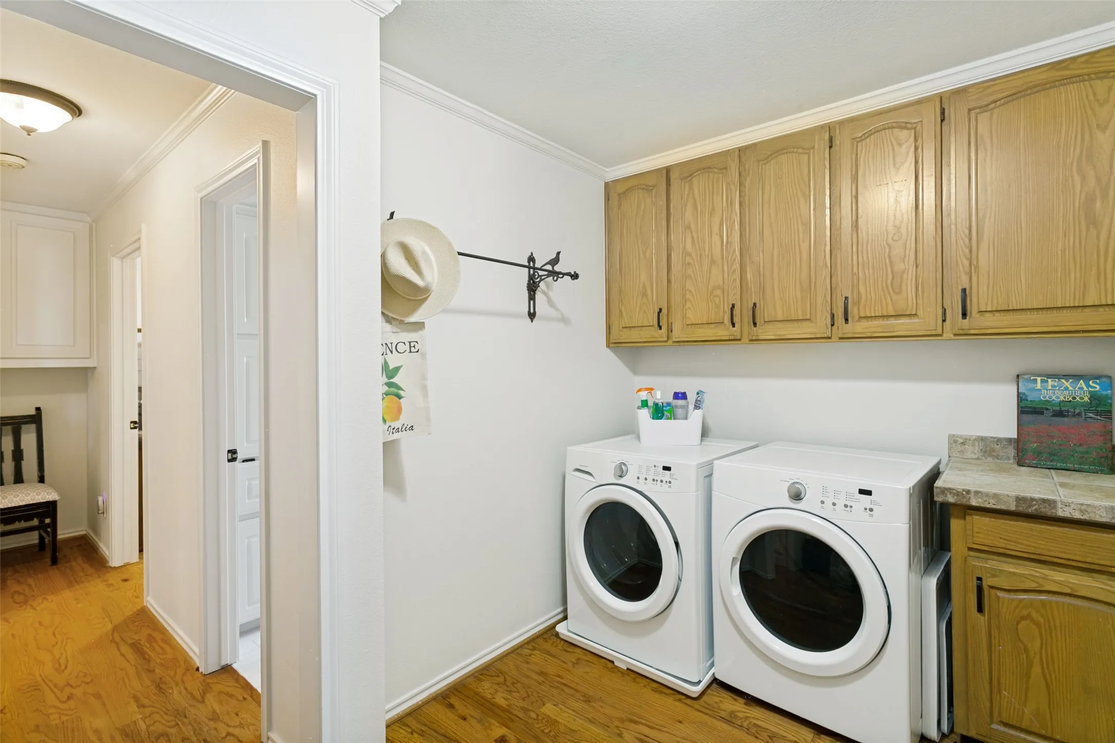This laundry room has plenty of storage and is located near the garage.