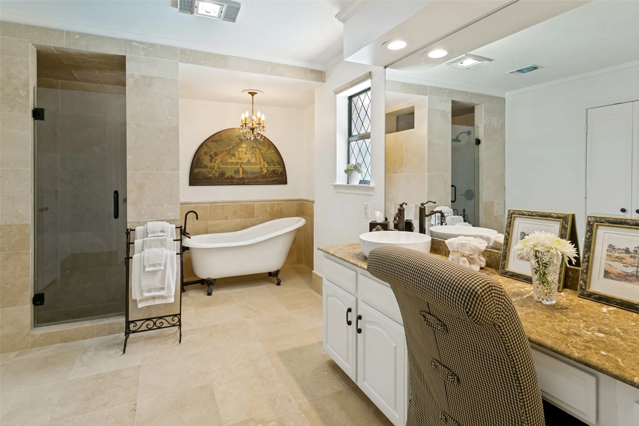 This oversized primary bathroom has a claw foot tub, as well as a separate shower.