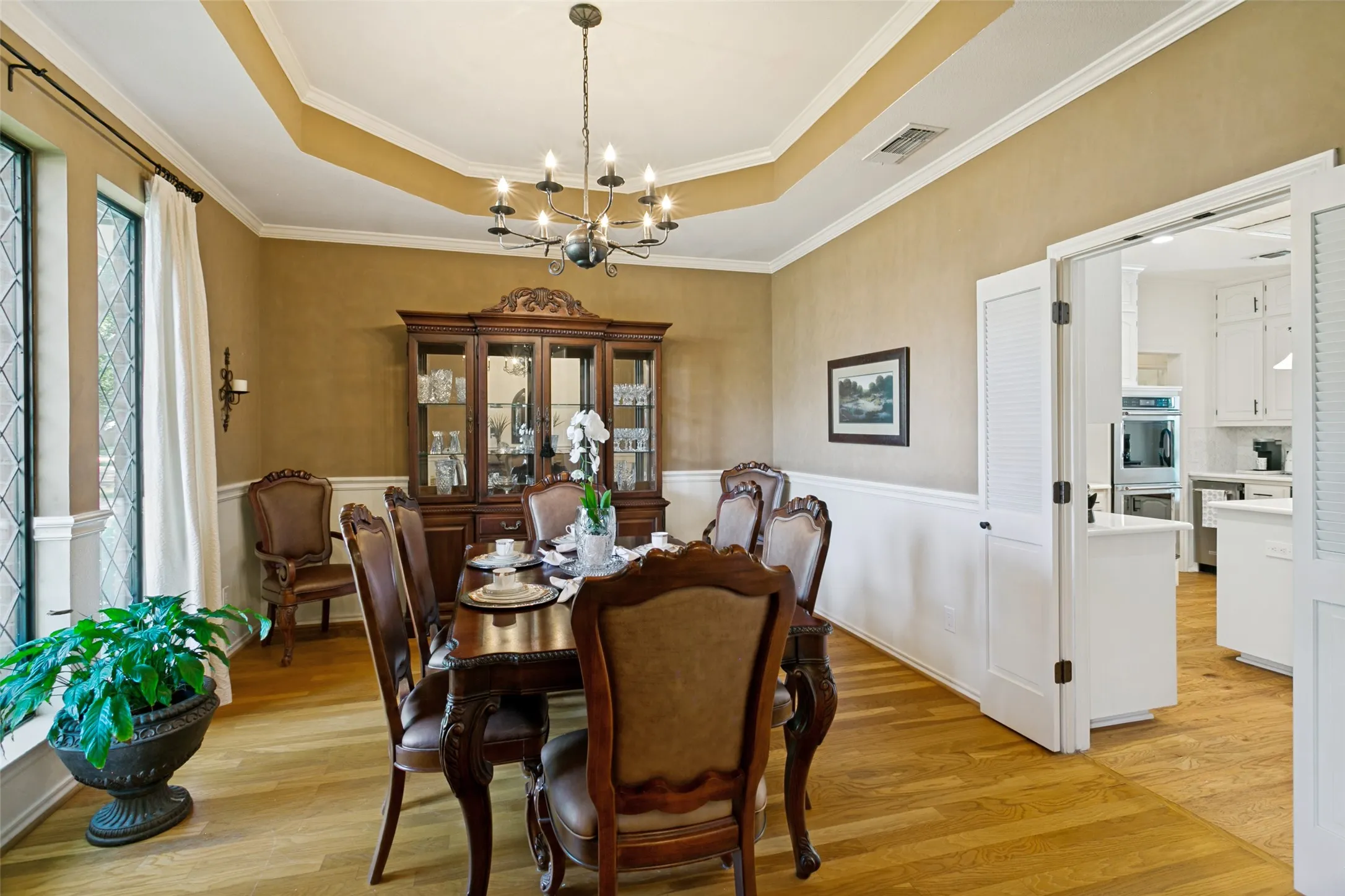 Dining room also features beautiful leaded glass windows and handsome wood flooring.