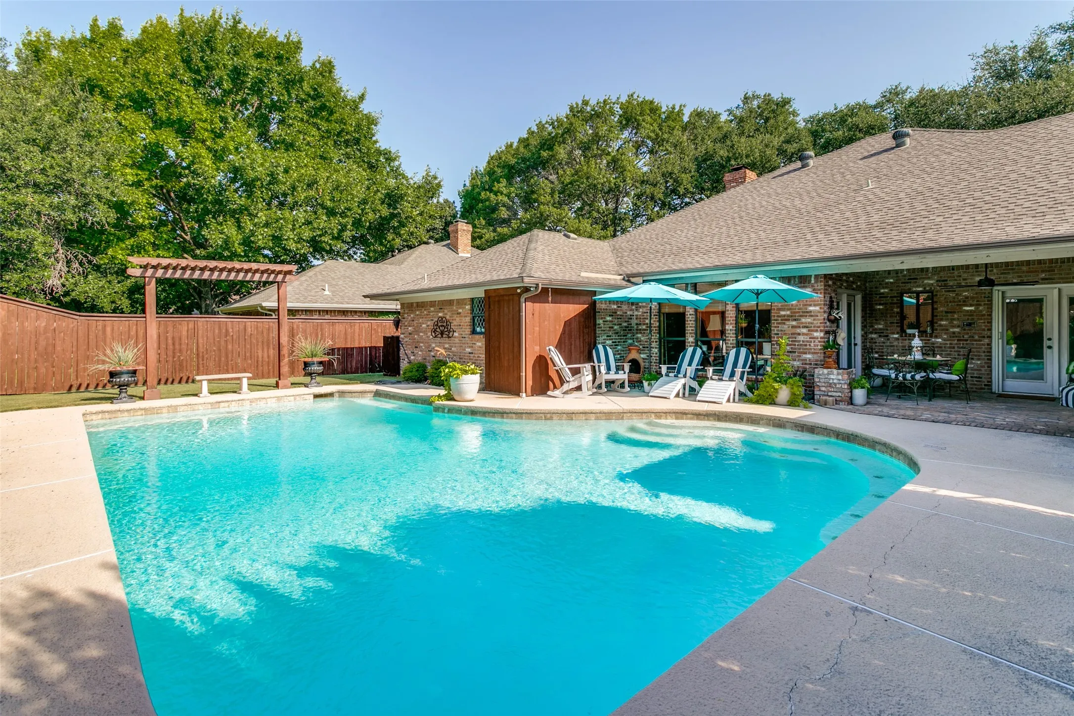 This sparkling pool creates a private back yard retreat!