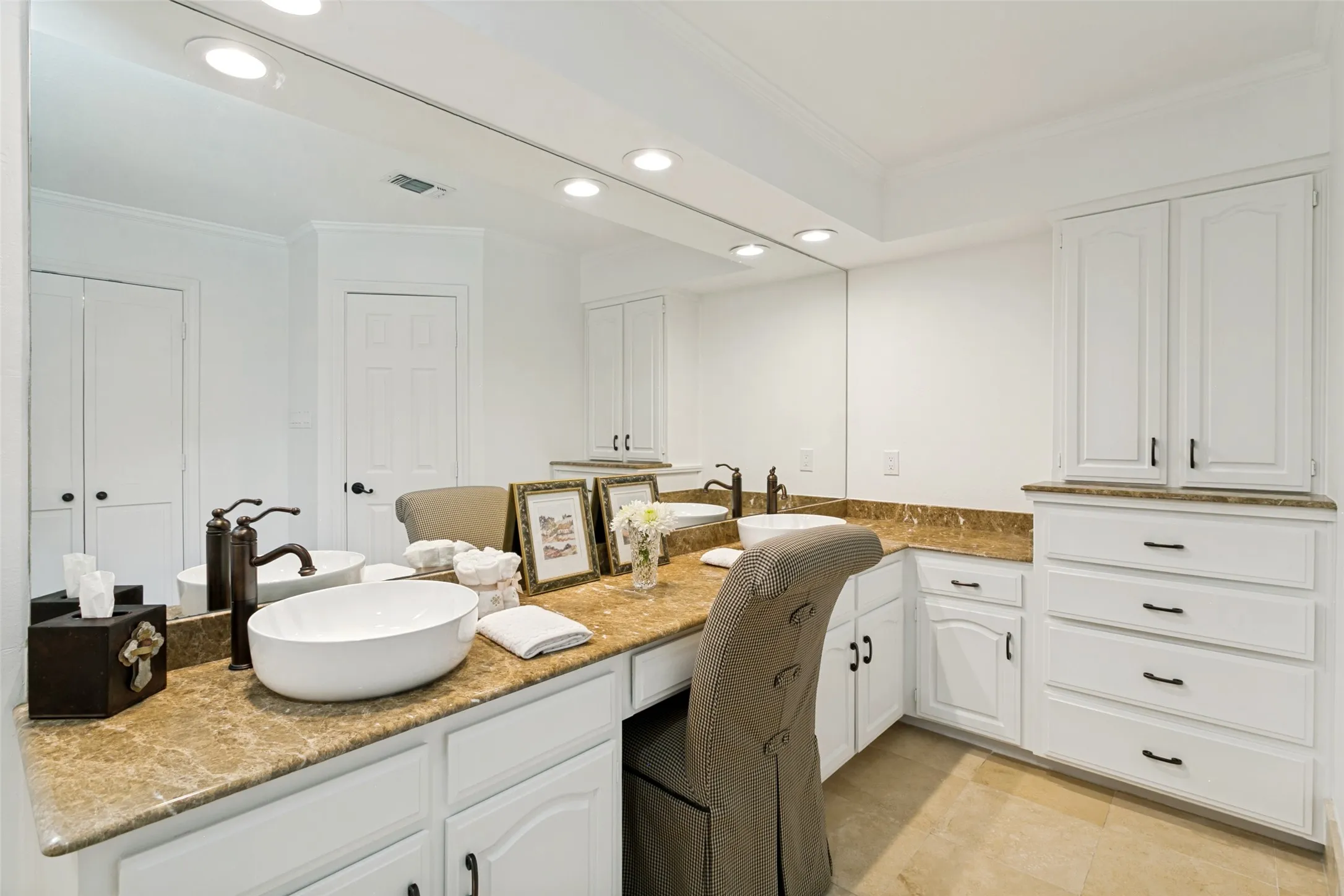 Elegant large double vanity with marble countertops.