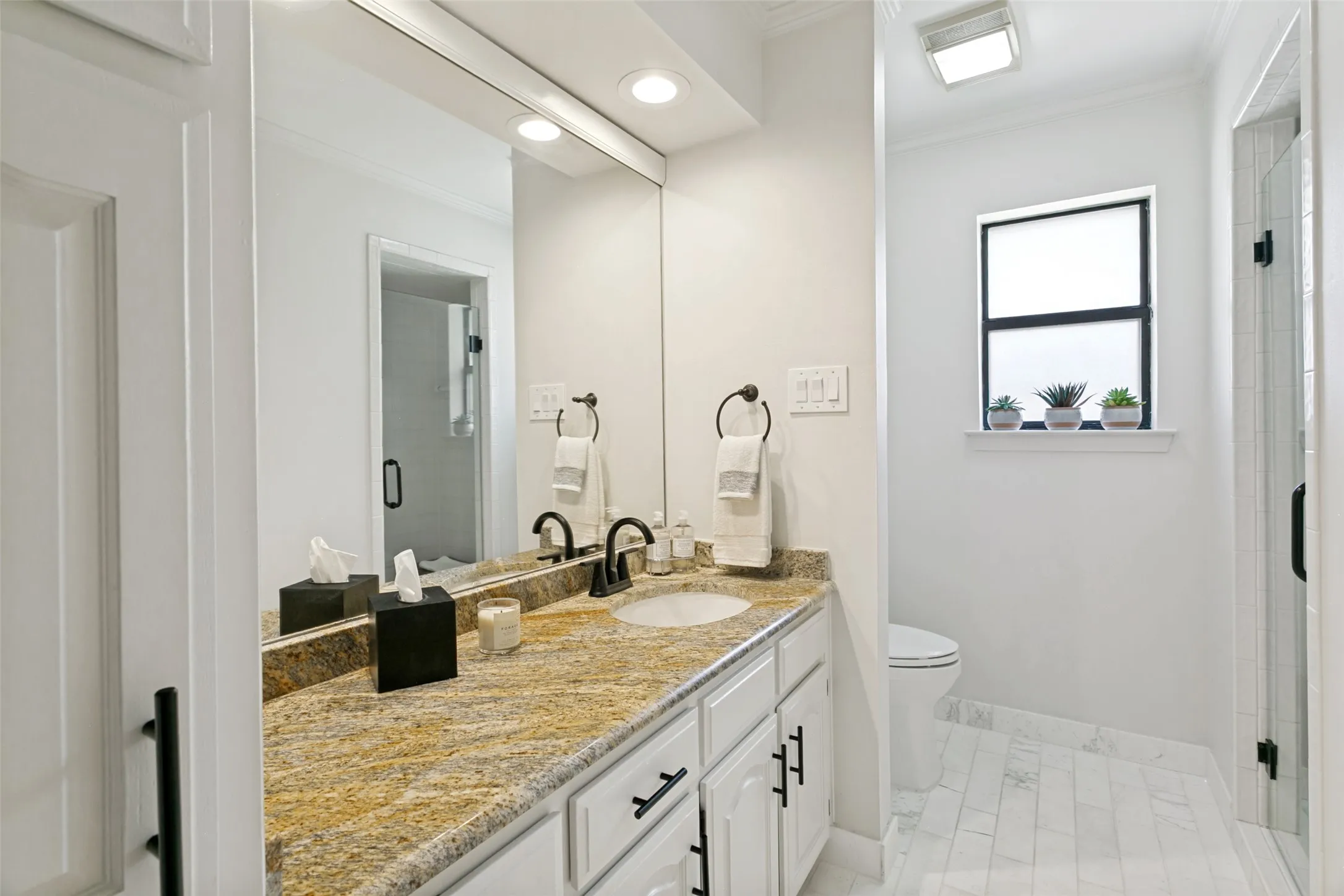 Beautifully  renovated third bathroom with granite countertops is next to the fourth bedroom.