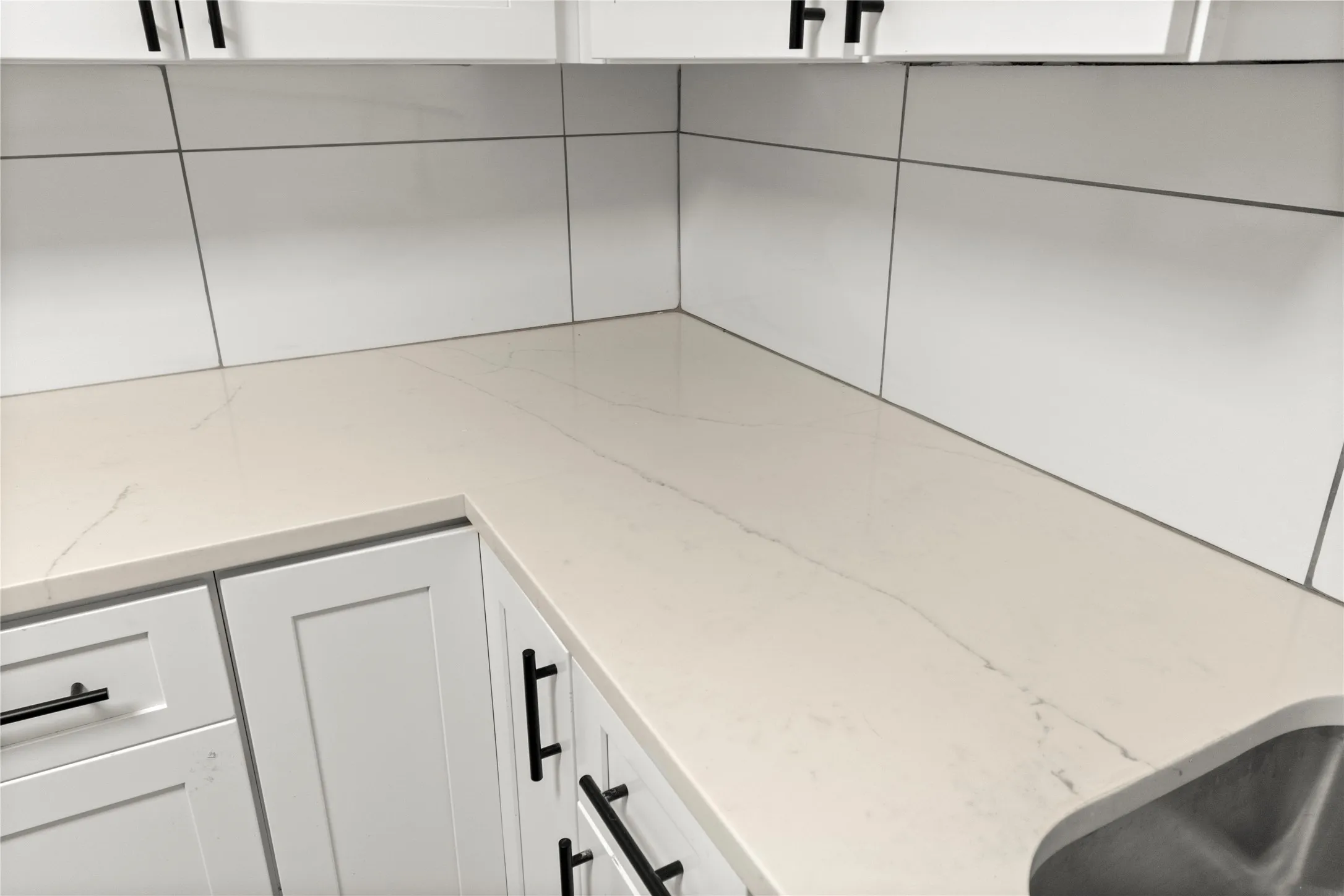 Quartz countertops with white shaker cabinets