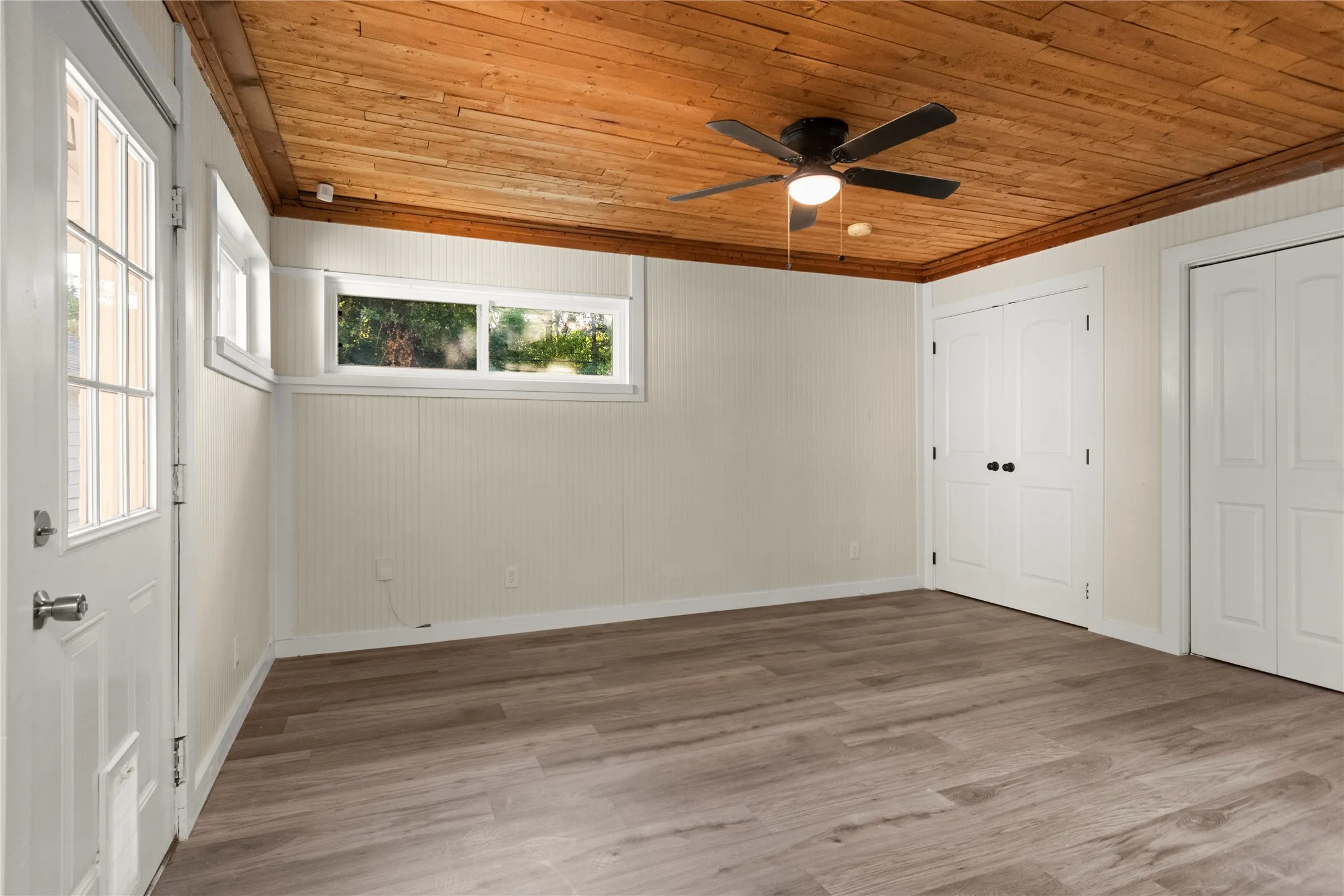 3rd bedroom or flex space. LVP flooring, wood plank ceiling, closet, laundry room and full-bathroom.
